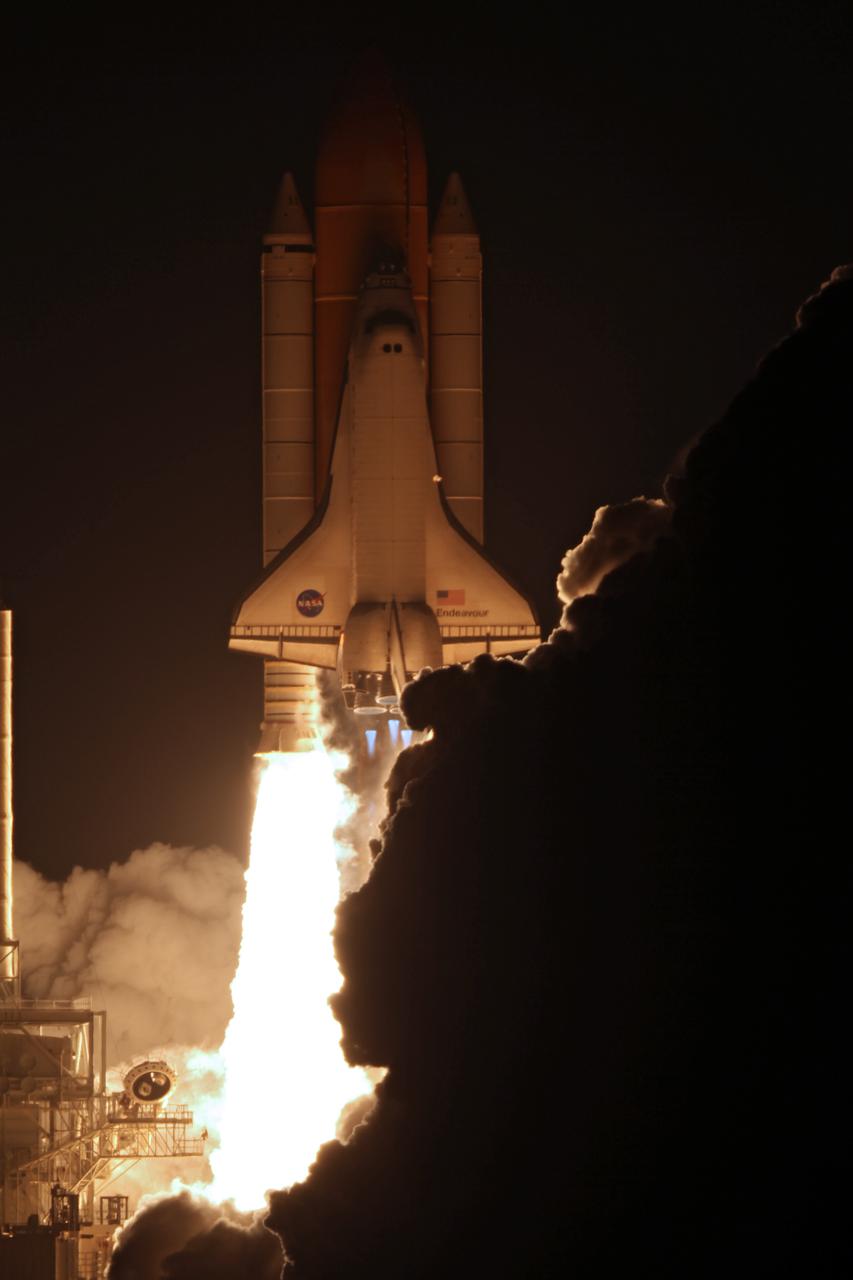 CAPE CANAVERAL, Fla. - Space shuttle Endeavour emerges from behind its exhaust plume as it lifts off from Launch Pad 39A at NASA's Kennedy Space Center in Florida. Launch of the STS-130 mission to the International Space Station was at 4:14 a.m. EST. This was the second launch attempt for space shuttle Endeavour's STS-130 crew and the final scheduled space shuttle night launch. The first attempt on Feb. 7 was scrubbed due to unfavorable weather. The primary payload for the STS-130 mission to the International Space Station is the Tranquility node, a pressurized module that will provide additional room for crew members and many of the station's life support and environmental control systems. Attached to one end of Tranquility is a cupola, a unique work area with six windows on its sides and one on top. The cupola resembles a circular bay window and will provide a vastly improved view of the station's exterior. The multi-directional view will allow the crew to monitor spacewalks and docking operations, as well as provide a spectacular view of Earth and other celestial objects. The module was built in Turin, Italy, by Thales Alenia Space for the European Space Agency. For information on the STS-130 mission and crew, visit http:__www.nasa.gov_mission_pages_shuttle_shuttlemissions_sts130_index.html. Photo credit: NASA_Kenny Allen