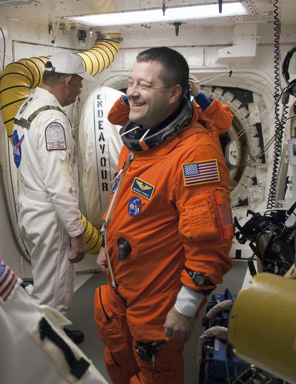 CAPE CANAVERAL, Fla. - In the White Room at Launch Pad 39A on NASA's Kennedy Space Center in Florida, STS-130 Mission Specialist Nicholas Patrick shares a light moment with United Space Alliance suit technicians and NASA quality inspectors as he prepares to enter space shuttle Endeavour for launch.  This is the second launch attempt for space shuttle Endeavour's STS-130 crew.  The first attempt on Feb. 7 was scrubbed due to unfavorable weather. The primary payload for the STS-130 mission to the International Space Station is the Tranquility node, a pressurized module that will provide additional room for crew members and many of the station's life support and environmental control systems. Attached to one end of Tranquility is a cupola, a unique work area with six windows on its sides and one on top.  The cupola resembles a circular bay window and will provide a vastly improved view of the station's exterior. The multi-directional view will allow the crew to monitor spacewalks and docking operations, as well as provide a spectacular view of Earth and other celestial objects. The module was built in Turin, Italy, by Thales Alenia Space for the European Space Agency.  Endeavour's launch is set for Feb. 8 at 4:14 a.m. EST.  For information on the STS-130 mission and crew, visit http:__www.nasa.gov_mission_pages_shuttle_shuttlemissions_sts130_index.html.  Photo credit: NASA_Sandra Joseph and Kevin O'Connell