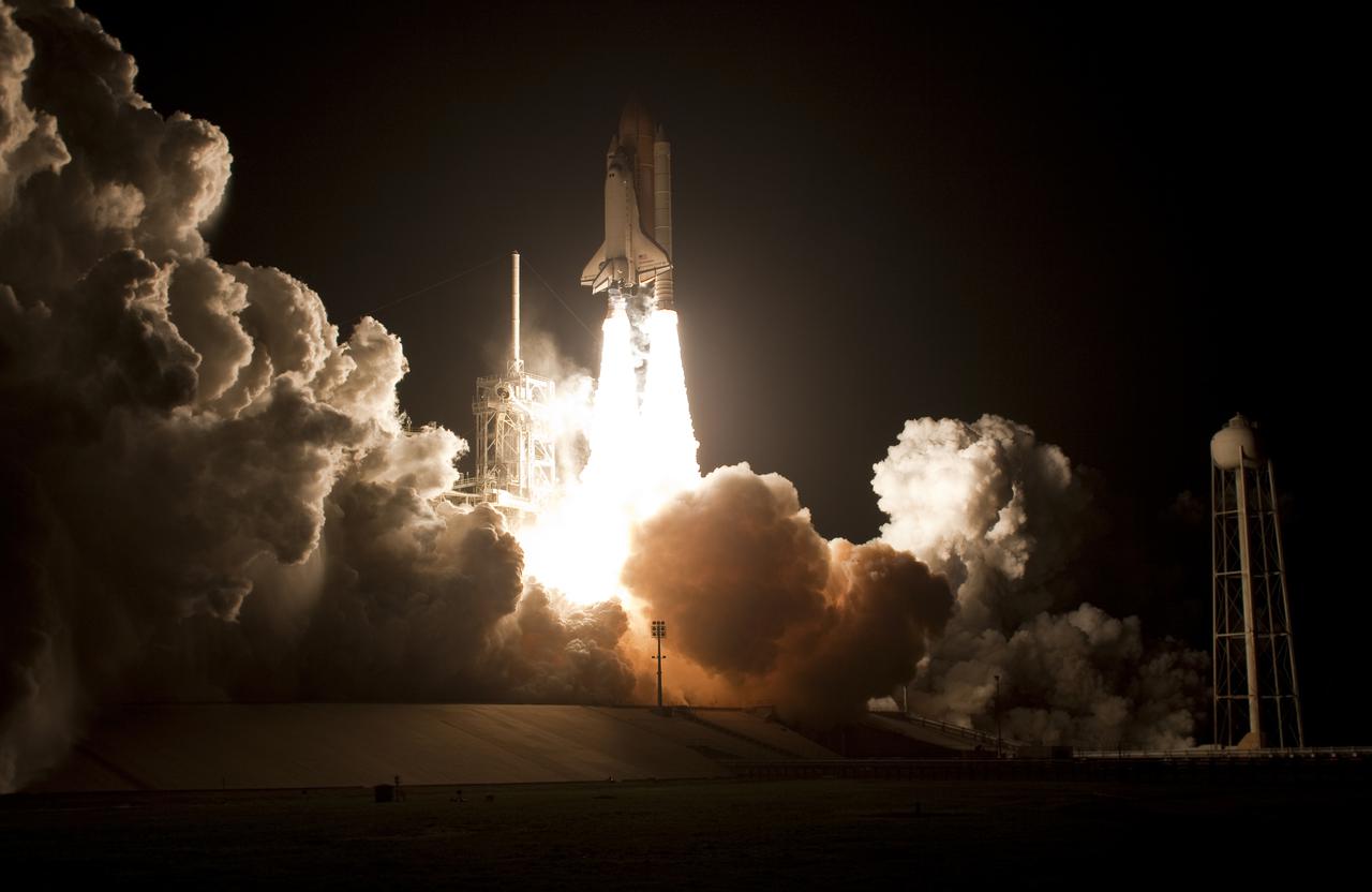 CAPE CANAVERAL, Fla. - An exhaust cloud forms under space shuttle Endeavour as it begins its climb to orbit from Launch Pad 39A at NASA's Kennedy Space Center in Florida.  Launch of the STS-130 mission to the International Space Station was at 4:14 a.m. EST.  This was the second launch attempt for space shuttle Endeavour's STS-130 crew and the final scheduled space shuttle night launch.  The first attempt on Feb. 7 was scrubbed due to unfavorable weather. The primary payload for the STS-130 mission to the International Space Station is the Tranquility node, a pressurized module that will provide additional room for crew members and many of the station's life support and environmental control systems. Attached to one end of Tranquility is a cupola, a unique work area with six windows on its sides and one on top.  The cupola resembles a circular bay window and will provide a vastly improved view of the station's exterior. The multi-directional view will allow the crew to monitor spacewalks and docking operations, as well as provide a spectacular view of Earth and other celestial objects. The module was built in Turin, Italy, by Thales Alenia Space for the European Space Agency.  For information on the STS-130 mission and crew, visit http:__www.nasa.gov_mission_pages_shuttle_shuttlemissions_sts130_index.html.  Photo courtesy of Scott Andrews