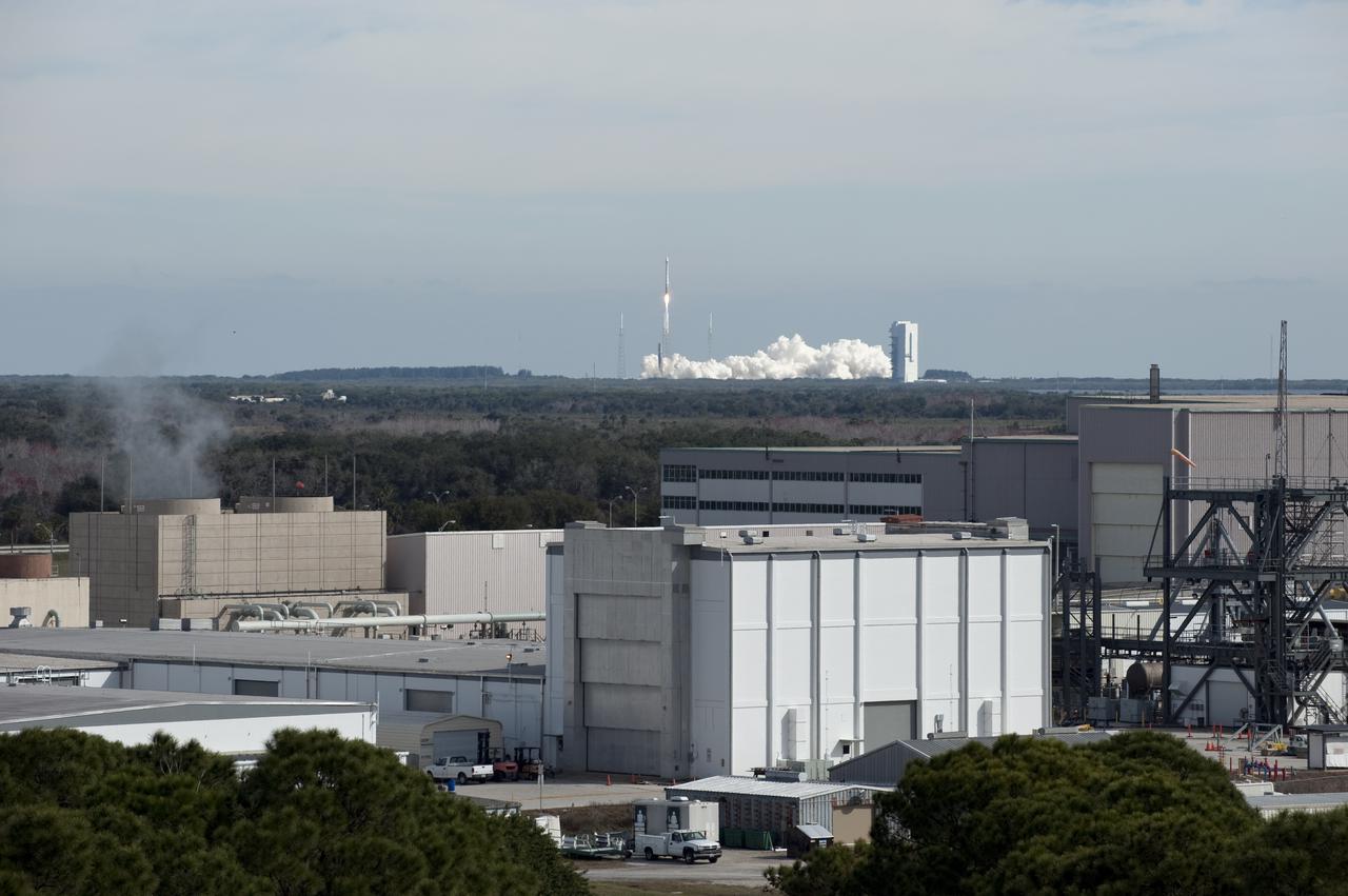 CAPE CANAVERAL, Fla. – This view shows the proximity of Launch Complex 41 on Cape Canaveral Air Force Station to the Industrial Area of NASA's Kennedy Space Center as a United Launch Alliance Atlas V rocket lifts off at 10:23 a.m. EST Feb. 11 carrying NASA's Solar Dynamics Observatory to orbit. This is the 100th launch of a commercial Atlas_Centaur rocket. The observatory, known as SDO, is the first mission in NASA's Living With a Star Program and is designed to study the causes of solar variability and its impacts on Earth. The spacecraft's long-term measurements will give solar scientists in-depth information to help characterize the interior of the Sun, the Sun's magnetic field, the hot plasma of the solar corona, and the density of radiation that creates the ionosphere of the planets. The information will be used to create better forecasts of space weather needed to protect the aircraft, satellites and astronauts living and working in space. For information on SDO, visit http:__www.nasa.gov_sdo. Photo credit: NASA_Tony Gray