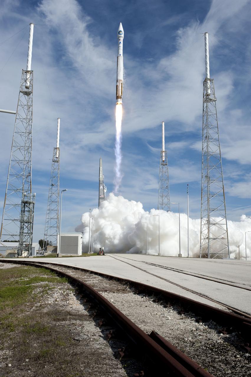 CAPE CANAVERAL, Fla. – A United Launch Alliance Atlas V rocket lifts off between the towers of the lightning protection system at Launch Complex 41 on Cape Canaveral Air Force Station at 10:23 a.m. EST Feb. 11 carrying NASA's Solar Dynamics Observatory to orbit.  This is the 100th launch of a commercial Atlas_Centaur rocket.  The observatory, known as SDO, is the first mission in NASA's Living With a Star Program and is designed to study the causes of solar variability and its impacts on Earth. The spacecraft's long-term measurements will give solar scientists in-depth information to help characterize the interior of the Sun, the Sun's magnetic field, the hot plasma of the solar corona, and the density of radiation that creates the ionosphere of the planets. The information will be used to create better forecasts of space weather needed to protect the aircraft, satellites and astronauts living and working in space. For information on SDO, visit http:__www.nasa.gov_sdo.  Photo credit: NASA_Sandra Joseph and Tony Gray
