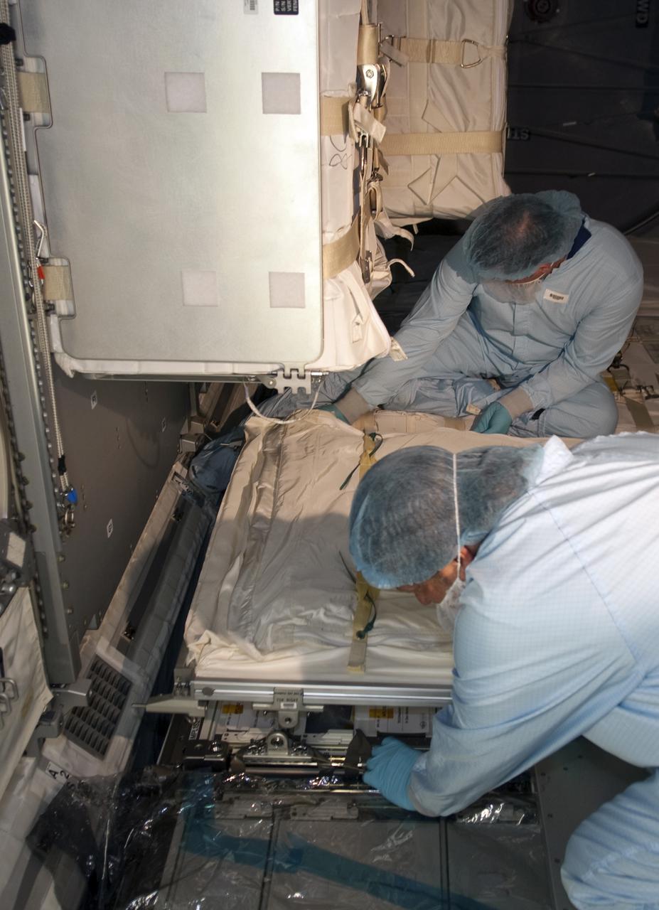 CAPE CANAVERAL, Fla. - In the Space Station Processing Facility at NASA's Kennedy Space Center in Florida, technicians install the zero-g storage rack into Multi-Purpose Logistics Module Leonardo. The seven-member STS-131 crew will deliver Leonardo, filled with resupply stowage platforms and racks, to the International Space Station aboard space shuttle Discovery. Work to attach a spare ammonia tank assembly to the station's exterior and return a European experiment from outside the station's Columbus module will be conducted during three spacewalks. STS-131, targeted for launch on April 5, will be the 33rd shuttle mission to the station and the 131st shuttle mission overall. For information on the STS-131 mission and crew, visit http:__www.nasa.gov_mission_pages_shuttle_shuttlemissions_sts131_index.html. Photo credit: NASA_Jim Grossmann