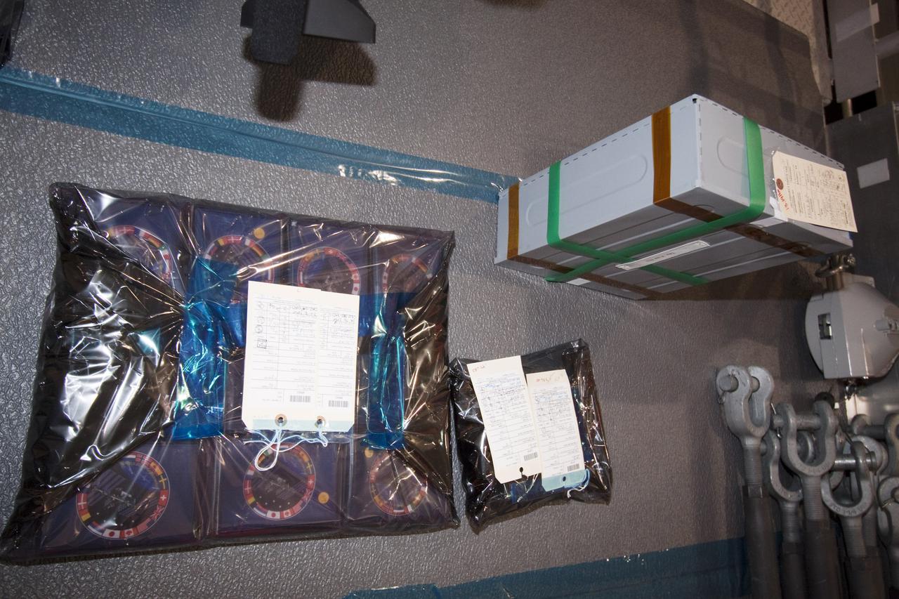 CAPE CANAVERAL, Fla. - In the Space Station Processing Facility at NASA's Kennedy Space Center in Florida, plastic bags contain International Space Station patches and other memorabilia that will be stored in the Multi-Purpose Logistics Module Leonardo and carried into space on its upcoming flight. The seven-member STS-131 crew will deliver Leonardo, filled with resupply stowage platforms and racks, to the International Space Station aboard space shuttle Discovery. On STS-131, work to attach a spare ammonia tank assembly to the station's exterior and return a European experiment from outside the station's Columbus module will be conducted during three spacewalks. Targeted for launch on April 5, STS-131 will be the 33rd shuttle mission to the station and the 131st shuttle mission overall. For information on the STS-131 mission and crew, visit http:__www.nasa.gov_mission_pages_shuttle_shuttlemissions_sts131_index.html. Photo credit: NASA_Amanda Diller