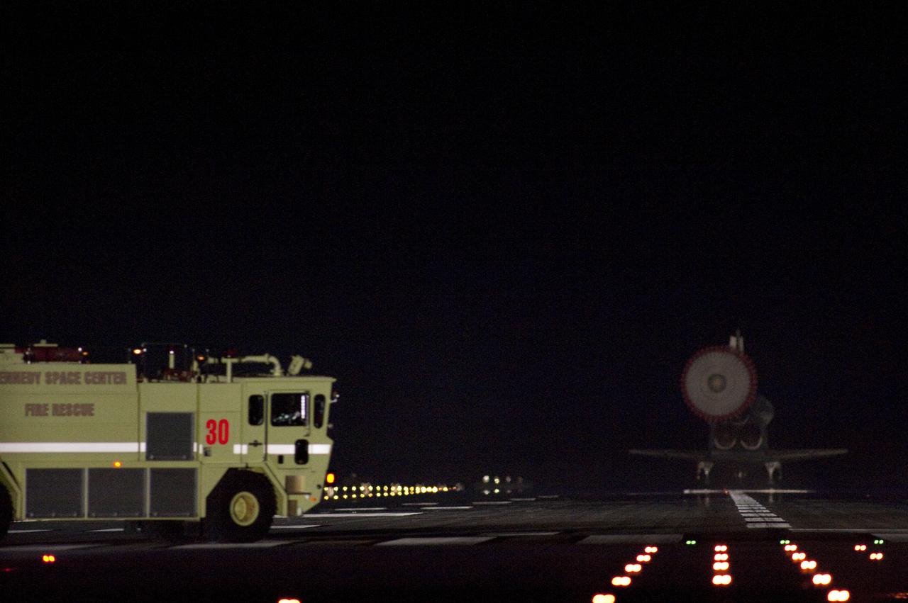 CAPE CANAVERAL, Fla. - A fire and rescue truck is in place beside Runway 15 if needed to support the landing of space shuttle Endeavour at the Shuttle Landing Facility at NASA's Kennedy Space Center in Florida.  After 14 days in space, Endeavour's 5.7-million-mile STS-130 mission is completed on orbit 217.  Main gear touchdown was at 10:20:31 p.m. EST followed by nose gear touchdown at 10:20:39 p.m. and wheels stop at 10:22:10 p.m.  It was the 23rd night landing in shuttle history and the 17th at Kennedy.  Aboard are Commander George Zamka; Pilot Terry Virts; and Mission Specialists Robert Behnken, Nicholas Patrick, Kathryn Hire and Stephen Robinson.  During Endeavour's STS-130 mission, astronauts installed the Tranquility node, a module that provides additional room for crew members and many of the station's life support and environmental control systems. Attached to Tranquility is a cupola with seven windows that provide a panoramic view of Earth, celestial objects and visiting spacecraft. The module was built in Turin, Italy, by Thales Alenia Space for the European Space Agency.  The orbiting laboratory is approximately 90 percent complete now in terms of mass.  STS-130 was the 24th flight for Endeavour, the 32nd shuttle mission devoted to ISS assembly and maintenance, and the 130th shuttle mission to date.  For information on the STS-130 mission and crew, visit http:__www.nasa.gov_mission_pages_shuttle_shuttlemissions_sts130.  Photo credit: NASA_Sandra Joseph and Kevin O'Connell