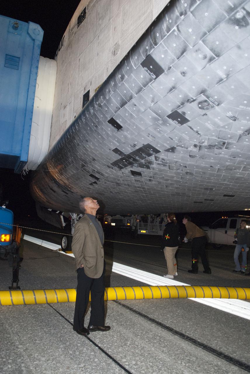 CAPE CANAVERAL, Fla. - NASA Administrator Charles Bolden examines the thermal protection system tiles under space shuttle Endeavour following its successful landing on Runway 15 at the Shuttle Landing Facility at NASA's Kennedy Space Center in Florida. After 14 days in space, Endeavour's 5.7-million-mile STS-130 mission was completed on orbit 217.  Main gear touchdown was at 10:20:31 p.m. EST followed by nose gear touchdown at 10:20:39 p.m. and wheels stop at 10:22:10 p.m.  It was the 23rd night landing in shuttle history and the 17th at Kennedy.  During Endeavour's STS-130 mission, astronauts installed the Tranquility node, a module that provides additional room for crew members and many of the station's life support and environmental control systems. Attached to Tranquility is a cupola with seven windows that provide a panoramic view of Earth, celestial objects and visiting spacecraft. The module was built in Turin, Italy, by Thales Alenia Space for the European Space Agency.  The orbiting laboratory is approximately 90 percent complete now in terms of mass.  STS-130 was the 24th flight for Endeavour, the 32nd shuttle mission devoted to ISS assembly and maintenance, and the 130th shuttle mission to date.  For information on the STS-130 mission and crew, visit http:__www.nasa.gov_mission_pages_shuttle_shuttlemissions_sts130_index.html.  Photo credit: NASA_Kim Shiflett