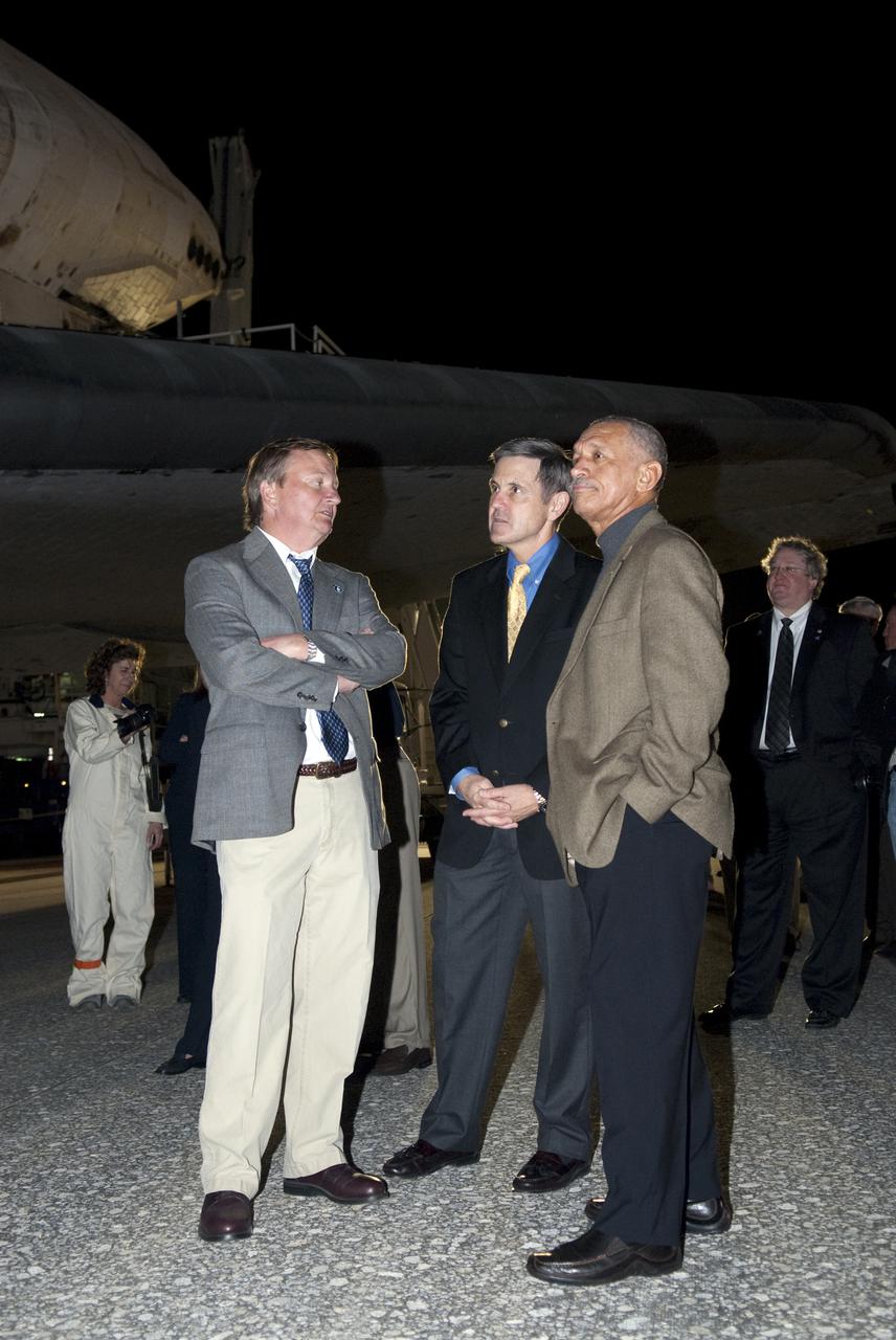 CAPE CANAVERAL, Fla. - NASA's Shuttle Launch Director Mike Leinbach, left, Kennedy Space Center Director Bob Cabana and NASA Administrator Charles Bolden wait to welcome the STS-130 crew back to Earth following space shuttle Endeavour's successful landing on Runway 15 at the Shuttle Landing Facility at NASA's Kennedy Space Center in Florida. At right, Bill Hill, NASA's assistant associate administrator for Space Shuttle Program, looks on. After 14 days in space, Endeavour's 5.7-million-mile STS-130 mission was completed on orbit 217.  Main gear touchdown was at 10:20:31 p.m. EST followed by nose gear touchdown at 10:20:39 p.m. and wheels stop at 10:22:10 p.m.  It was the 23rd night landing in shuttle history and the 17th at Kennedy.  During Endeavour's STS-130 mission, astronauts installed the Tranquility node, a module that provides additional room for crew members and many of the station's life support and environmental control systems. Attached to Tranquility is a cupola with seven windows that provide a panoramic view of Earth, celestial objects and visiting spacecraft. The module was built in Turin, Italy, by Thales Alenia Space for the European Space Agency.  The orbiting laboratory is approximately 90 percent complete now in terms of mass.  STS-130 was the 24th flight for Endeavour, the 32nd shuttle mission devoted to ISS assembly and maintenance, and the 130th shuttle mission to date.  For information on the STS-130 mission and crew, visit http:__www.nasa.gov_mission_pages_shuttle_shuttlemissions_sts130_index.html.  Photo credit: NASA_Kim Shiflett