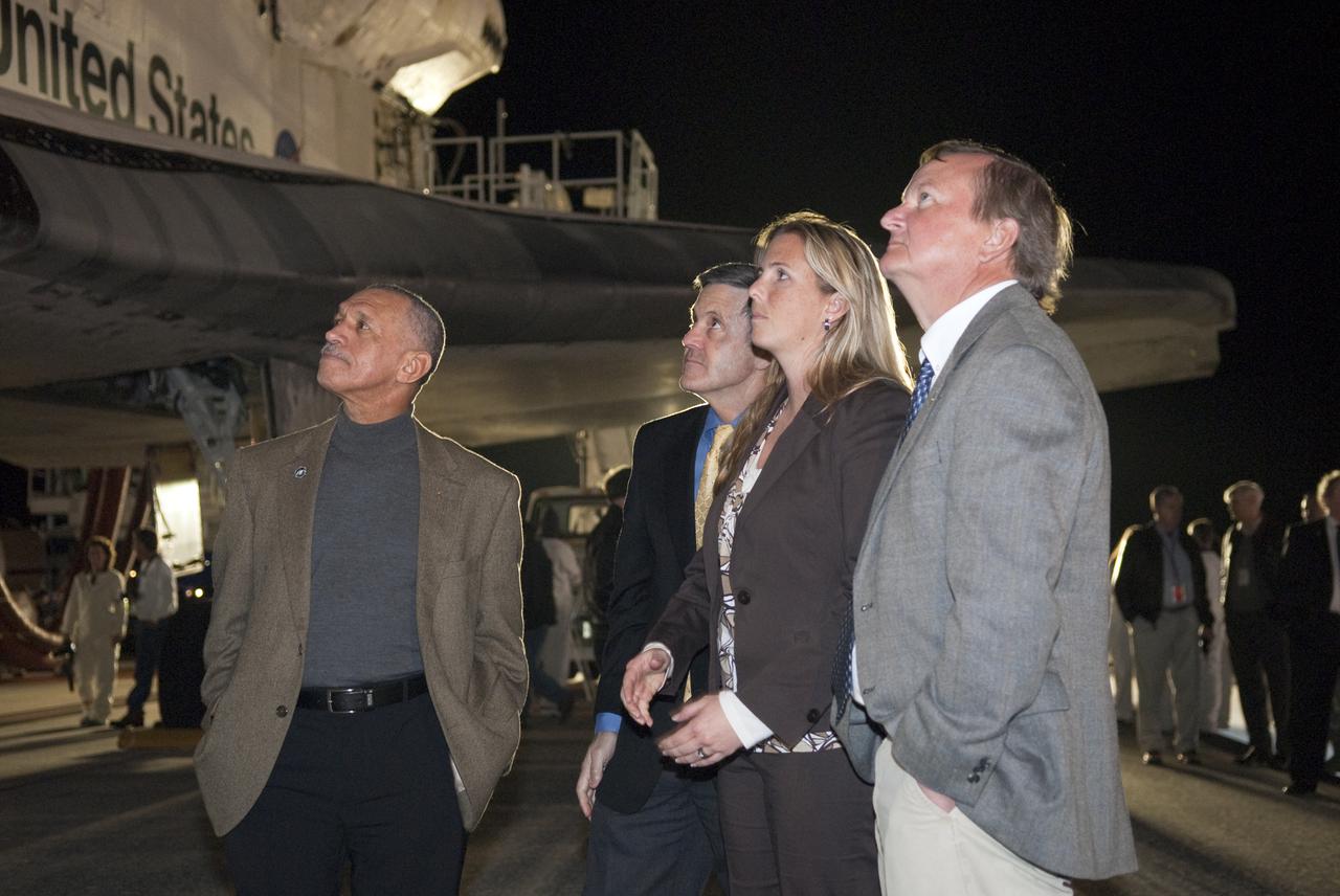 CAPE CANAVERAL, Fla. - From left, NASA Administrator Charles Bolden, Kennedy Space Center Director Bob Cabana, Flow Director for space shuttle Endeavour Dana Hutcherson, and Shuttle Launch Director Mike Leinbach get a close look at Endeavour as they wait to greet the STS-130 crew following Endeavour's successful landing on Runway 15 at the Shuttle Landing Facility at NASA's Kennedy Space Center in Florida. After 14 days in space, Endeavour's 5.7-million-mile STS-130 mission was completed on orbit 217.  Main gear touchdown was at 10:20:31 p.m. EST followed by nose gear touchdown at 10:20:39 p.m. and wheels stop at 10:22:10 p.m.  It was the 23rd night landing in shuttle history and the 17th at Kennedy.  During Endeavour's STS-130 mission, astronauts installed the Tranquility node, a module that provides additional room for crew members and many of the station's life support and environmental control systems. Attached to Tranquility is a cupola with seven windows that provide a panoramic view of Earth, celestial objects and visiting spacecraft. The module was built in Turin, Italy, by Thales Alenia Space for the European Space Agency.  The orbiting laboratory is approximately 90 percent complete now in terms of mass.  STS-130 was the 24th flight for Endeavour, the 32nd shuttle mission devoted to ISS assembly and maintenance, and the 130th shuttle mission to date.  For information on the STS-130 mission and crew, visit http:__www.nasa.gov_mission_pages_shuttle_shuttlemissions_sts130_index.html.  Photo credit: NASA_Kim Shiflett