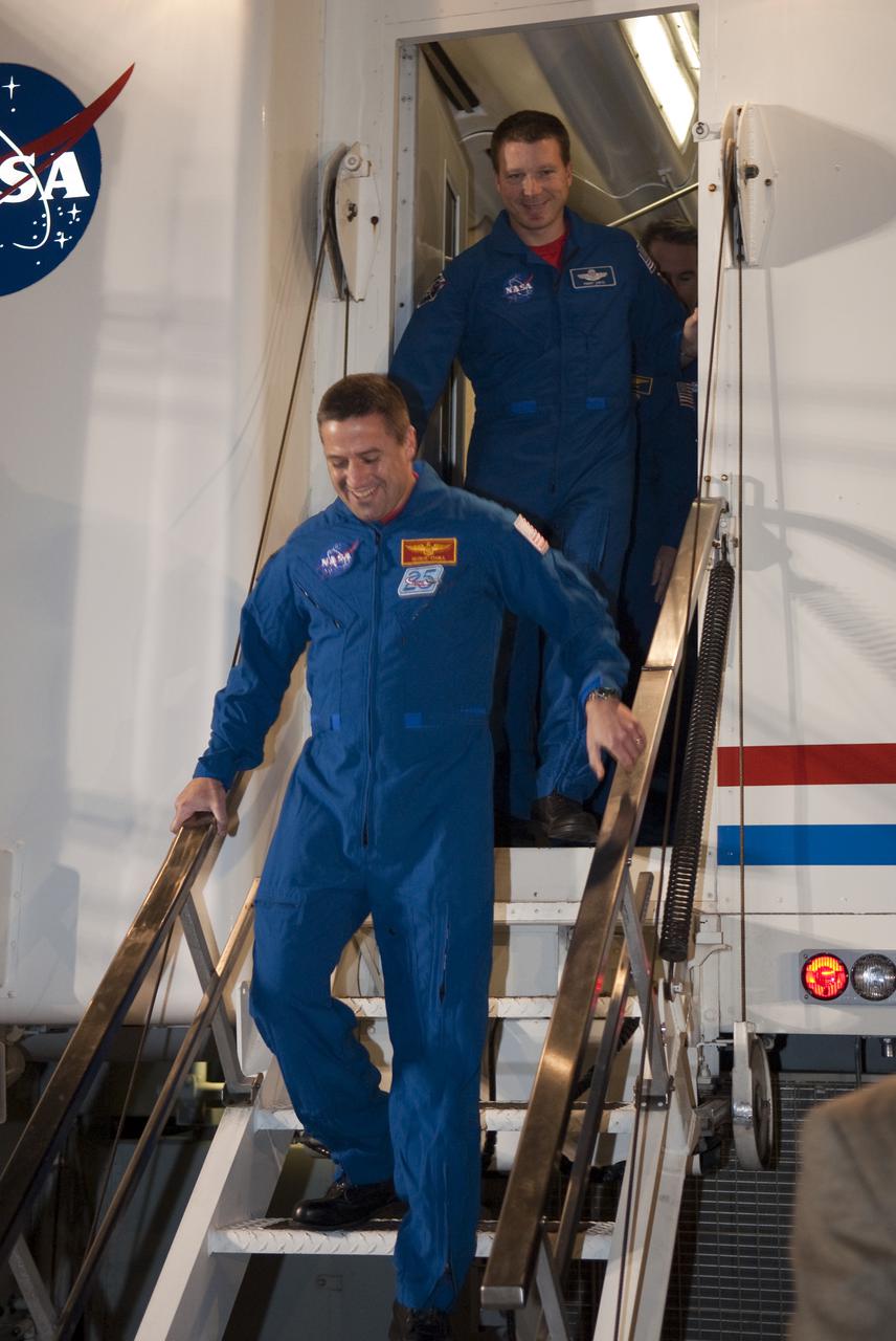 CAPE CANAVERAL, Fla. - STS-130 Commander George Zamka leaves the astronaut support vehicle, followed by Pilot Terry Virts, following space shuttle Endeavour's successful landing on Runway 15 at the Shuttle Landing Facility at NASA's Kennedy Space Center in Florida. After 14 days in space, Endeavour's 5.7-million-mile STS-130 mission was completed on orbit 217.  Main gear touchdown was at 10:20:31 p.m. EST followed by nose gear touchdown at 10:20:39 p.m. and wheels stop at 10:22:10 p.m.  It was the 23rd night landing in shuttle history and the 17th at Kennedy.  During Endeavour's STS-130 mission, astronauts installed the Tranquility node, a module that provides additional room for crew members and many of the station's life support and environmental control systems. Attached to Tranquility is a cupola with seven windows that provide a panoramic view of Earth, celestial objects and visiting spacecraft. The module was built in Turin, Italy, by Thales Alenia Space for the European Space Agency.  The orbiting laboratory is approximately 90 percent complete now in terms of mass.  STS-130 was the 24th flight for Endeavour, the 32nd shuttle mission devoted to ISS assembly and maintenance, and the 130th shuttle mission to date.  For information on the STS-130 mission and crew, visit http:__www.nasa.gov_mission_pages_shuttle_shuttlemissions_sts130_index.html.  Photo credit: NASA_Kim Shiflett