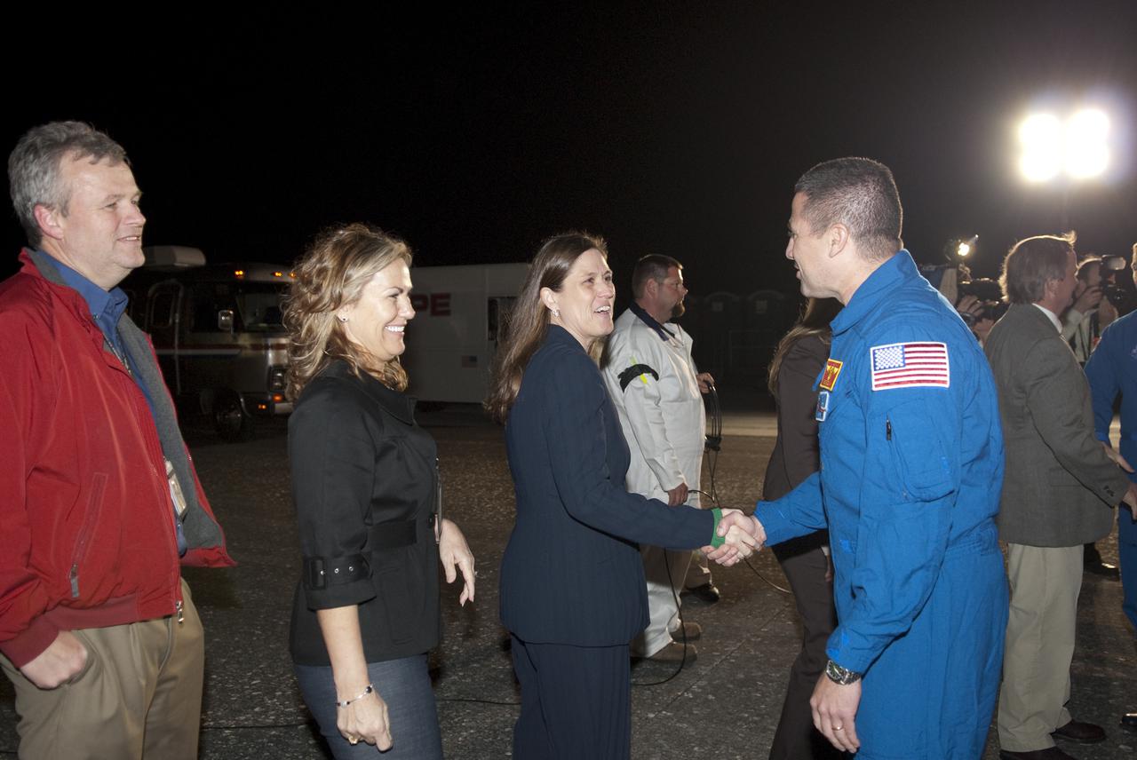 CAPE CANAVERAL, Fla. - STS-130 Commander George Zamka, in the blue flight suit, gets a warm welcome back to NASA's Kennedy Space Center in Florida from Rita Willcoxon, director of Launch Vehicle Processing, following space shuttle Endeavour's successful landing on Runway 15 at Kennedy's Shuttle Landing Facility. After 14 days in space, Endeavour's 5.7-million-mile STS-130 mission was completed on orbit 217.  Main gear touchdown was at 10:20:31 p.m. EST followed by nose gear touchdown at 10:20:39 p.m. and wheels stop at 10:22:10 p.m.  It was the 23rd night landing in shuttle history and the 17th at Kennedy.  During Endeavour's STS-130 mission, astronauts installed the Tranquility node, a module that provides additional room for crew members and many of the station's life support and environmental control systems. Attached to Tranquility is a cupola with seven windows that provide a panoramic view of Earth, celestial objects and visiting spacecraft. The module was built in Turin, Italy, by Thales Alenia Space for the European Space Agency.  The orbiting laboratory is approximately 90 percent complete now in terms of mass.  STS-130 was the 24th flight for Endeavour, the 32nd shuttle mission devoted to ISS assembly and maintenance, and the 130th shuttle mission to date.  For information on the STS-130 mission and crew, visit http:__www.nasa.gov_mission_pages_shuttle_shuttlemissions_sts130_index.html.  Photo credit: NASA_Kim Shiflett