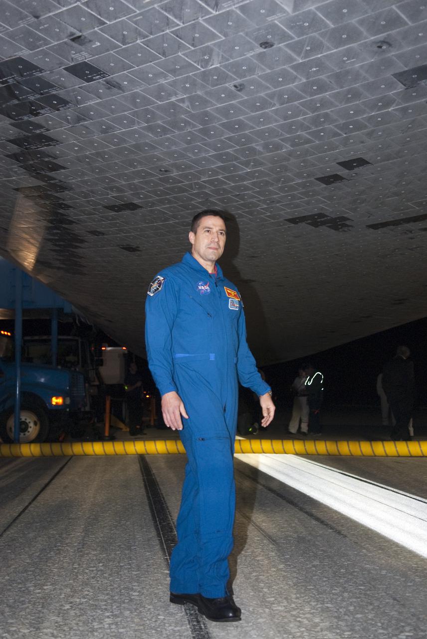 CAPE CANAVERAL, Fla. - STS-130 Commander George Zamka inspects the thermal protection system tiles under space shuttle Endeavour following its successful landing on Runway 15 at the Shuttle Landing Facility at NASA's Kennedy Space Center in Florida. After 14 days in space, Endeavour's 5.7-million-mile STS-130 mission was completed on orbit 217.  Main gear touchdown was at 10:20:31 p.m. EST followed by nose gear touchdown at 10:20:39 p.m. and wheels stop at 10:22:10 p.m.  It was the 23rd night landing in shuttle history and the 17th at Kennedy.  During Endeavour's STS-130 mission, astronauts installed the Tranquility node, a module that provides additional room for crew members and many of the station's life support and environmental control systems. Attached to Tranquility is a cupola with seven windows that provide a panoramic view of Earth, celestial objects and visiting spacecraft. The module was built in Turin, Italy, by Thales Alenia Space for the European Space Agency.  The orbiting laboratory is approximately 90 percent complete now in terms of mass.  STS-130 was the 24th flight for Endeavour, the 32nd shuttle mission devoted to ISS assembly and maintenance, and the 130th shuttle mission to date.  For information on the STS-130 mission and crew, visit http:__www.nasa.gov_mission_pages_shuttle_shuttlemissions_sts130_index.html.  Photo credit: NASA_Kim Shiflett