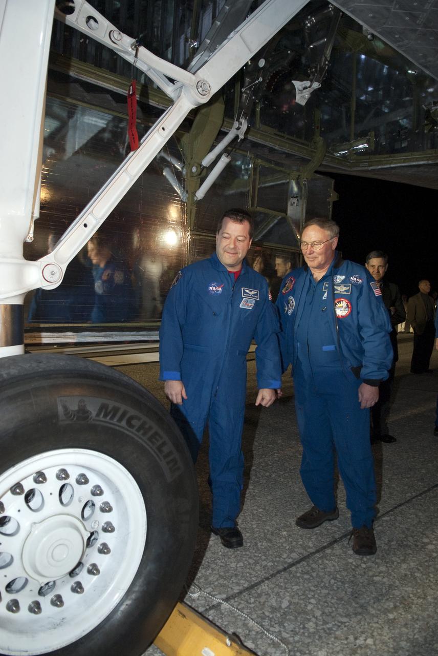 CAPE CANAVERAL, Fla. - STS-130 Mission Specialist Nicholas Patrick, left, inspects the tires on space shuttle Endeavour following its successful landing on Runway 15 at the Shuttle Landing Facility at NASA's Kennedy Space Center in Florida. Looking on, at right, is astronaut Jerry Ross, chief of the Vehicle Integration Test Office at the Johnson Space Center.  After 14 days in space, Endeavour's 5.7-million-mile STS-130 mission was completed on orbit 217.  Main gear touchdown was at 10:20:31 p.m. EST followed by nose gear touchdown at 10:20:39 p.m. and wheels stop at 10:22:10 p.m.  It was the 23rd night landing in shuttle history and the 17th at Kennedy.  During Endeavour's STS-130 mission, astronauts installed the Tranquility node, a module that provides additional room for crew members and many of the station's life support and environmental control systems. Attached to Tranquility is a cupola with seven windows that provide a panoramic view of Earth, celestial objects and visiting spacecraft. The module was built in Turin, Italy, by Thales Alenia Space for the European Space Agency.  The orbiting laboratory is approximately 90 percent complete now in terms of mass.  STS-130 was the 24th flight for Endeavour, the 32nd shuttle mission devoted to ISS assembly and maintenance, and the 130th shuttle mission to date.  For information on the STS-130 mission and crew, visit http:__www.nasa.gov_mission_pages_shuttle_shuttlemissions_sts130_index.html.  Photo credit: NASA_Kim Shiflett