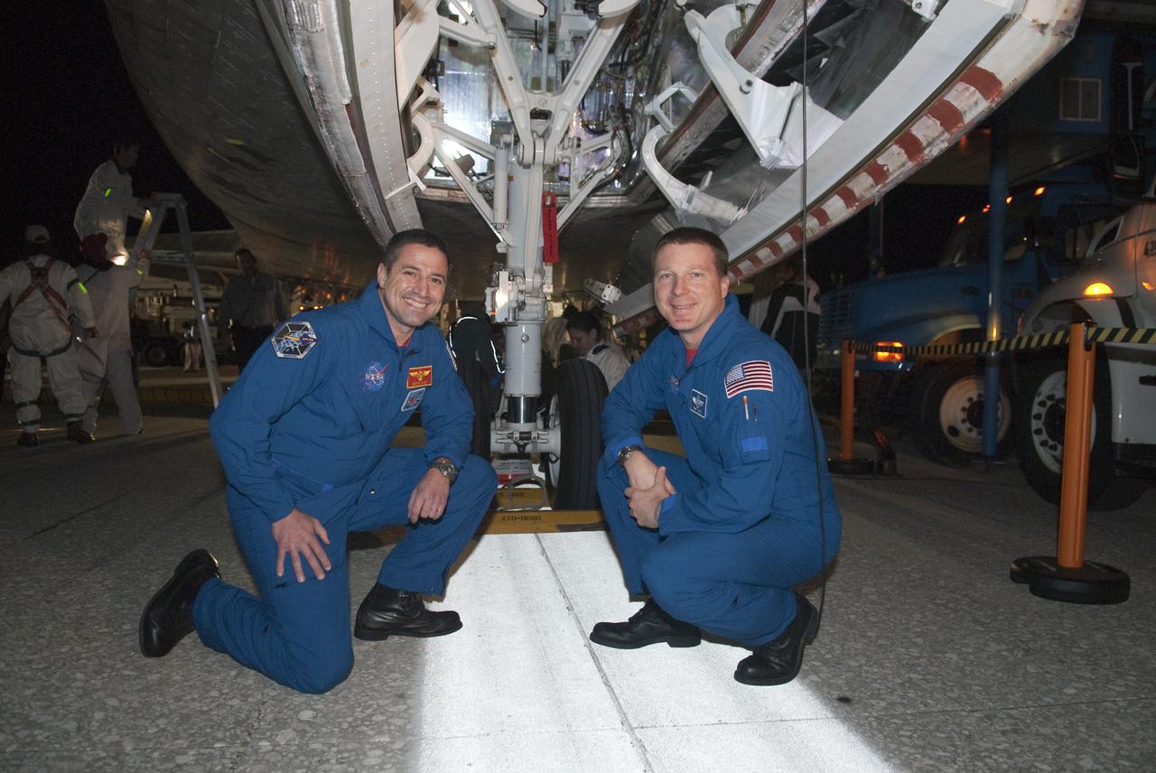 CAPE CANAVERAL, Fla. - STS-130 Commander George Zamka, left, and Pilot Terry Virts pause for a photograph in front of space shuttle Endeavour's nose gear following its successful landing on Runway 15 at the Shuttle Landing Facility at NASA's Kennedy Space Center in Florida. After 14 days in space, Endeavour's 5.7-million-mile STS-130 mission was completed on orbit 217. Main gear touchdown was at 10:20:31 p.m. EST followed by nose gear touchdown at 10:20:39 p.m. and wheels stop at 10:22:10 p.m. It was the 23rd night landing in shuttle history and the 17th at Kennedy. During Endeavour's STS-130 mission, astronauts installed the Tranquility node, a module that provides additional room for crew members and many of the station's life support and environmental control systems. Attached to Tranquility is a cupola with seven windows that provide a panoramic view of Earth, celestial objects and visiting spacecraft. The module was built in Turin, Italy, by Thales Alenia Space for the European Space Agency. The orbiting laboratory is approximately 90 percent complete now in terms of mass. STS-130 was the 24th flight for Endeavour, the 32nd shuttle mission devoted to ISS assembly and maintenance, and the 130th shuttle mission to date. For information on the STS-130 mission and crew, visit http:__www.nasa.gov_mission_pages_shuttle_shuttlemissions_sts130_index.html. Photo credit: NASA_Kim Shiflett