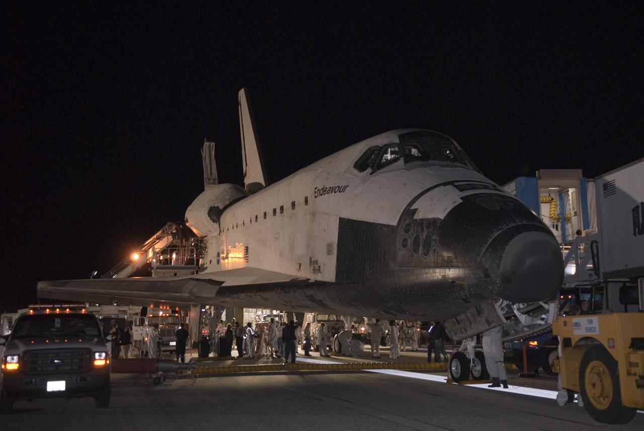 CAPE CANAVERAL, Fla. - Space shuttle Endeavour is prepared for transport to the Orbiter Processing Facility following its successful landing on Runway 15 at the Shuttle Landing Facility at NASA's Kennedy Space Center in Florida. After 14 days in space, Endeavour's 5.7-million-mile STS-130 mission was completed on orbit 217.  Main gear touchdown was at 10:20:31 p.m. EST followed by nose gear touchdown at 10:20:39 p.m. and wheels stop at 10:22:10 p.m.  It was the 23rd night landing in shuttle history and the 17th at Kennedy.  During Endeavour's STS-130 mission, astronauts installed the Tranquility node, a module that provides additional room for crew members and many of the station's life support and environmental control systems. Attached to Tranquility is a cupola with seven windows that provide a panoramic view of Earth, celestial objects and visiting spacecraft. The module was built in Turin, Italy, by Thales Alenia Space for the European Space Agency.  The orbiting laboratory is approximately 90 percent complete now in terms of mass.  STS-130 was the 24th flight for Endeavour, the 32nd shuttle mission devoted to ISS assembly and maintenance, and the 130th shuttle mission to date.  For information on the STS-130 mission and crew, visit http:__www.nasa.gov_mission_pages_shuttle_shuttlemissions_sts130_index.html.  Photo credit: NASA_Kim Shiflett