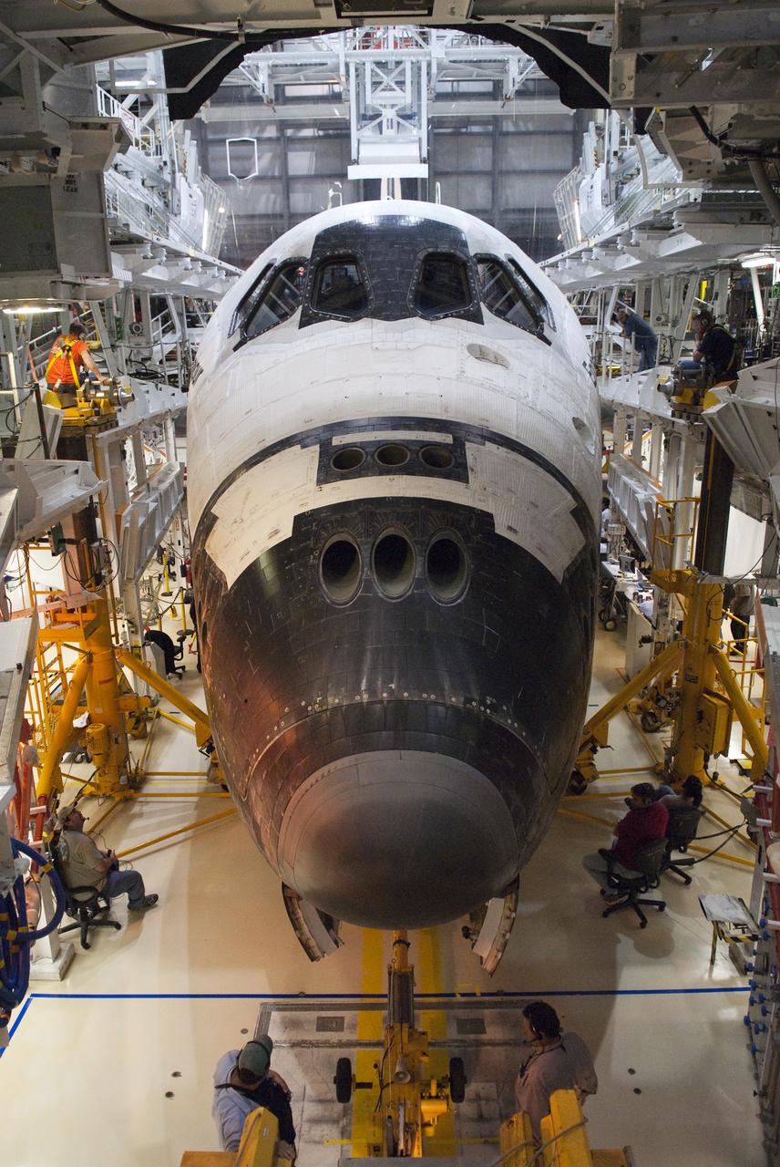CAPE CANAVERAL, Fla. - At NASA's Kennedy Space Center in Florida, workers monitor the placement of space shuttle Endeavour in Orbiter Processing Facility-2.  Endeavour's touchdown at Kennedy's Shuttle Landing Facility following the STS-130 mission to the International Space Station was at 10:20 p.m. EST Feb. 21.  Processing now will begin for Endeavour's next flight, STS-134.  The six-member STS-134 crew will deliver Express Logistics Carrier 3 and the Alpha Magnetic Spectrometer to the International Space Station, as well as a variety of spare parts including two S-band communications antennas, a high-pressure gas tank, additional spare parts for Dextre and micrometeoroid debris shields. STS-134 will be the 35th shuttle mission to the station and the 133rd flight in the shuttle program.  Launch is targeted for July 29. For information on the STS-134 mission and crew, visit http:__www.nasa.gov_mission_pages_shuttle_shuttlemissions_sts134_index.html.  Photo credit: NASA_Kim Shiflett