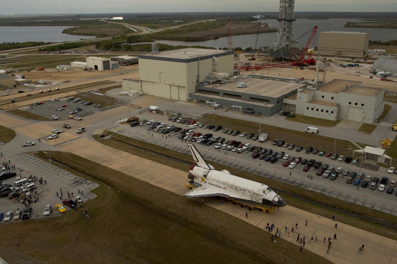 CAPE CANAVERAL, Fla. - At NASA's Kennedy Space Center in Florida, workers accompany space shuttle Discovery as it is moved from Orbiter Processing Facility-3 to the Vehicle Assembly Building, or VAB. In the VAB, Discovery will be lifted into a high bay where it will be mated to its external tank and solid rocket boosters. The seven-member STS-131 crew will deliver the Multi-Purpose Logistics Module Leonardo, filled with resupply stowage platforms and racks, to the International Space Station aboard space shuttle Discovery. Work to attach a spare ammonia tank assembly to the station's exterior and return a European experiment from outside the station's Columbus module will be conducted during three spacewalks. STS-131, targeted for launch on April 5, will be the 33rd shuttle mission to the station and the 131st shuttle mission overall. For information on the STS-131 mission and crew, visit http:__www.nasa.gov_mission_pages_shuttle_shuttlemissions_sts131_index.html.  Photo courtesy of Scott Andrews