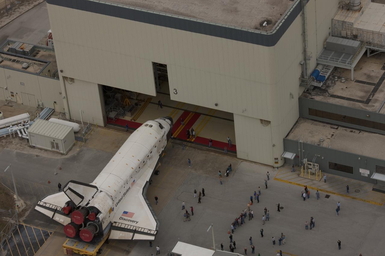 CAPE CANAVERAL, Fla. - At NASA's Kennedy Space Center in Florida, space shuttle Discovery rolls through the Vehicle Assembly Building, or VAB, transfer aisle entrance. In the VAB, Discovery will be lifted into a high bay where it will be mated to its external tank and solid rocket boosters. The seven-member STS-131 crew will deliver the Multi-Purpose Logistics Module Leonardo, filled with resupply stowage platforms and racks, to the International Space Station aboard space shuttle Discovery. Work to attach a spare ammonia tank assembly to the station's exterior and return a European experiment from outside the station's Columbus module will be conducted during three spacewalks. STS-131, targeted for launch on April 5, will be the 33rd shuttle mission to the station and the 131st shuttle mission overall. For information on the STS-131 mission and crew, visit http:__www.nasa.gov_mission_pages_shuttle_shuttlemissions_sts131_index.html.  Photo courtesy of Scott Andrews
