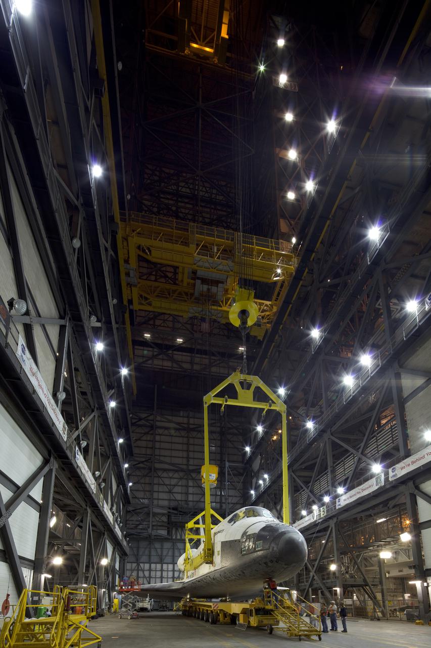 CAPE CANAVERAL, Fla. - In the transfer aisle of the Vehicle Assembly Building, or VAB, at NASA's Kennedy Space Center in Florida, preparations are under way to attach space shuttle Discovery to a lifting device for its move into a high bay.  In the high bay, Discovery will be attached to its external tank and solid rocket boosters completing the STS-131 shuttle stack. Rollout to Launch Pad 39A is planned for March 2.  The seven-member STS-131 crew will deliver the Multi-Purpose Logistics Module Leonardo, filled with resupply stowage platforms and racks, to the International Space Station aboard space shuttle Discovery.  Work to attach a spare ammonia tank assembly to the station's exterior and return a European experiment from outside the station's Columbus module will be conducted during three spacewalks.  STS-131, targeted for launch on April 5, will be the 33rd shuttle mission to the station and the 131st shuttle mission overall. For information on the STS-131 mission and crew, visit http:__www.nasa.gov_mission_pages_shuttle_shuttlemissions_sts131_index.html.  Photo courtesy of Scott Andrews and Stan Jirman
