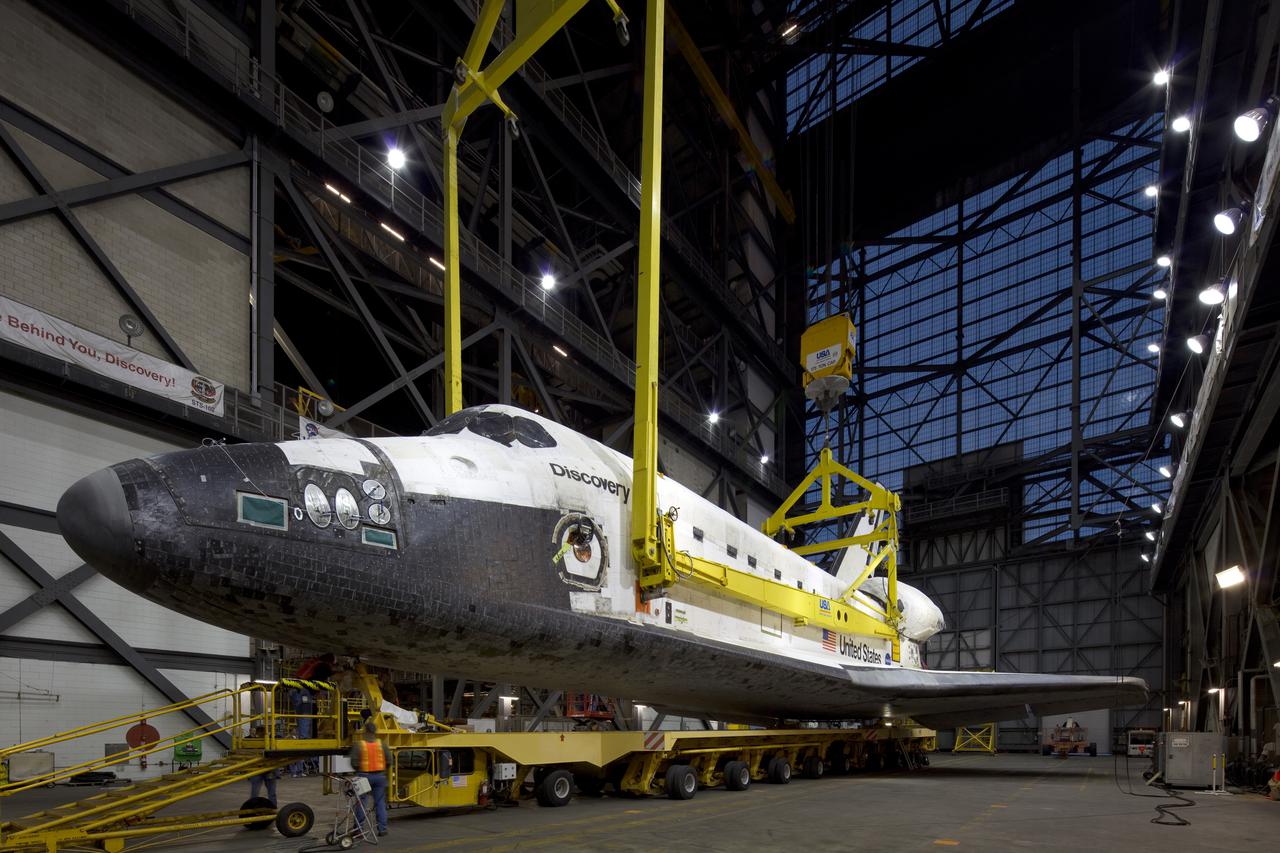 CAPE CANAVERAL, Fla. - In the transfer aisle of the Vehicle Assembly Building, or VAB, at NASA's Kennedy Space Center in Florida, preparations are under way to attach space shuttle Discovery to a lifting device for its move into a high bay.  In the high bay, Discovery will be attached to its external tank and solid rocket boosters completing the STS-131 shuttle stack. Rollout to Launch Pad 39A is planned for March 2.  The seven-member STS-131 crew will deliver the Multi-Purpose Logistics Module Leonardo, filled with resupply stowage platforms and racks, to the International Space Station aboard space shuttle Discovery.  Work to attach a spare ammonia tank assembly to the station's exterior and return a European experiment from outside the station's Columbus module will be conducted during three spacewalks.  STS-131, targeted for launch on April 5, will be the 33rd shuttle mission to the station and the 131st shuttle mission overall. For information on the STS-131 mission and crew, visit http:__www.nasa.gov_mission_pages_shuttle_shuttlemissions_sts131_index.html.  Photo courtesy of Scott Andrews and Stan Jirman