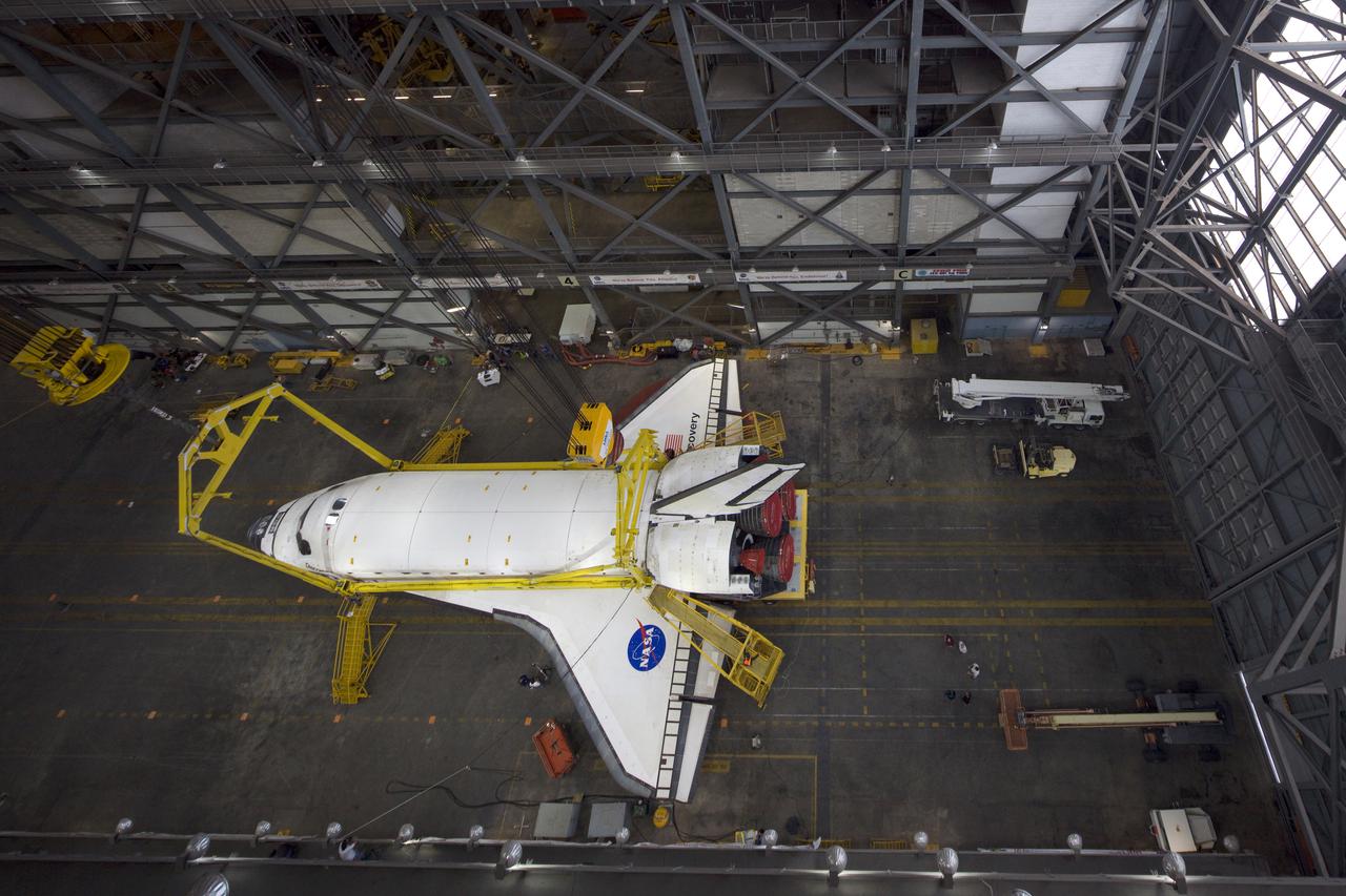 CAPE CANAVERAL, Fla. - In the transfer aisle of the Vehicle Assembly Building, or VAB, at NASA's Kennedy Space Center in Florida, space shuttle Discovery is prepared for its lift from the transfer aisle into a high bay.  In the high bay, Discovery will be attached to its external tank and solid rocket boosters completing the STS-131 shuttle stack. Rollout to Launch Pad 39A is planned for March 2.  The seven-member STS-131 crew will deliver the Multi-Purpose Logistics Module Leonardo, filled with resupply stowage platforms and racks, to the International Space Station aboard space shuttle Discovery.  Work to attach a spare ammonia tank assembly to the station's exterior and return a European experiment from outside the station's Columbus module will be conducted during three spacewalks.  STS-131, targeted for launch on April 5, will be the 33rd shuttle mission to the station and the 131st shuttle mission overall. For information on the STS-131 mission and crew, visit http:__www.nasa.gov_mission_pages_shuttle_shuttlemissions_sts131_index.html.  Photo courtesy of Scott Andrews and Stan Jirman