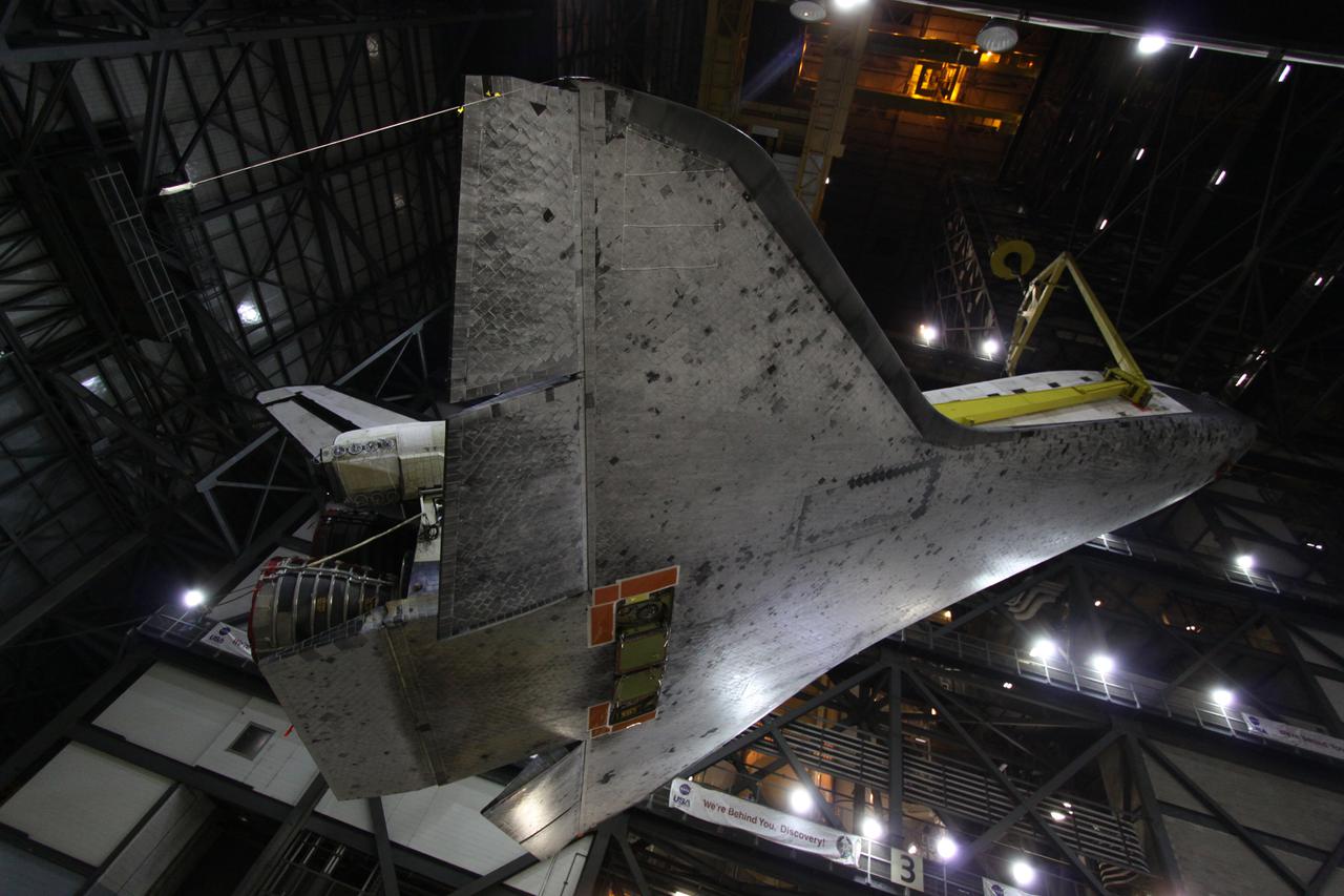 CAPE CANAVERAL, Fla. - In the Vehicle Assembly Building, or VAB, at NASA's Kennedy Space Center in Florida, space shuttle Discovery is rotated into a vertical position over the transfer aisle for its move into a high bay.  In the high bay, Discovery will be attached to its external fuel tank and solid rocket boosters completing the STS-131 shuttle stack. Rollout to Launch Pad 39A is planned for March 2.  The seven-member STS-131 crew will deliver the Multi-Purpose Logistics Module Leonardo, filled with resupply stowage platforms and racks, to the International Space Station aboard space shuttle Discovery.  Work to attach a spare ammonia tank assembly to the station's exterior and return a European experiment from outside the station's Columbus module will be conducted during three spacewalks.  STS-131, targeted for launch on April 5, will be the 33rd shuttle mission to the station and the 131st shuttle mission overall. For information on the STS-131 mission and crew, visit http:__www.nasa.gov_mission_pages_shuttle_shuttlemissions_sts131_index.html.  Photo credit: NASA_Troy Cryder