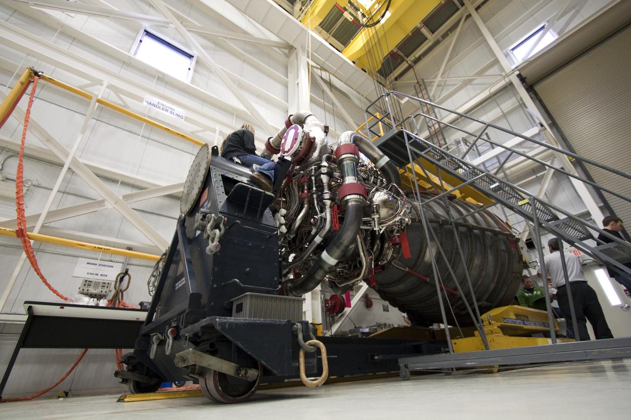 CAPE CANAVERAL, Fla. - In the Space Shuttle Main Engine Processing Facility at NASA's Kennedy Space Center in Florida, workers prepare to lift a space shuttle main engine onto a transporter for its move to Orbiter Processing Facility-1, the hangar in which space shuttle Atlantis is being processed for its upcoming STS-132 mission. A main engine is 14 feet long, weighs approximately 7,000 pounds, and is 7.5 feet in diameter at the end of the nozzle. Inspection and maintenance of each of the shuttle's three main engines are an important safety measure and standard procedure between shuttle missions. Atlantis is scheduled to deliver an Integrated Cargo Carrier and Russian-built Mini Research Module to the International Space Station on STS-132. The second in a series of new pressurized components for Russia, the module will be permanently attached to the Zarya module. Three spacewalks are planned to store spare components outside the station, including six spare batteries, a boom assembly for the Ku-band antenna and spares for the Canadian Dextre robotic arm extension. A radiator, airlock and European robotic arm for the Russian Multi-purpose Laboratory Module also are payloads on the flight. Launch is targeted for May 14. Photo credit: NASA_Troy Cryder