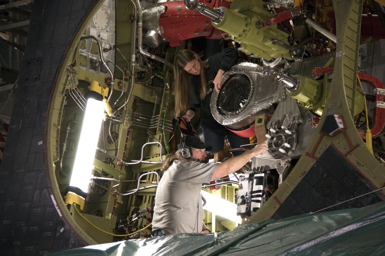 CAPE CANAVERAL, Fla. - In Orbiter Processing Facility-1 at NASA's Kennedy Space Center in Florida, workers inside space shuttle Atlantis' aft end prepare to install space shuttle main engine #2 on Atlantis for its upcoming STS-132 mission. A main engine is 14 feet long, weighs approximately 7,000 pounds, and is 7.5 feet in diameter at the end of the nozzle. Inspection and maintenance of each of the shuttle's three main engines are an important safety measure and standard procedure between shuttle missions. Atlantis is scheduled to deliver an Integrated Cargo Carrier and Russian-built Mini Research Module to the International Space Station on STS-132. The second in a series of new pressurized components for Russia, the module will be permanently attached to the Zarya module. Three spacewalks are planned to store spare components outside the station, including six spare batteries, a boom assembly for the Ku-band antenna and spares for the Canadian Dextre robotic arm extension. A radiator, airlock and European robotic arm for the Russian Multi-purpose Laboratory Module also are payloads on the flight. Launch is targeted for May 14. Photo credit: NASA_Troy Cryder