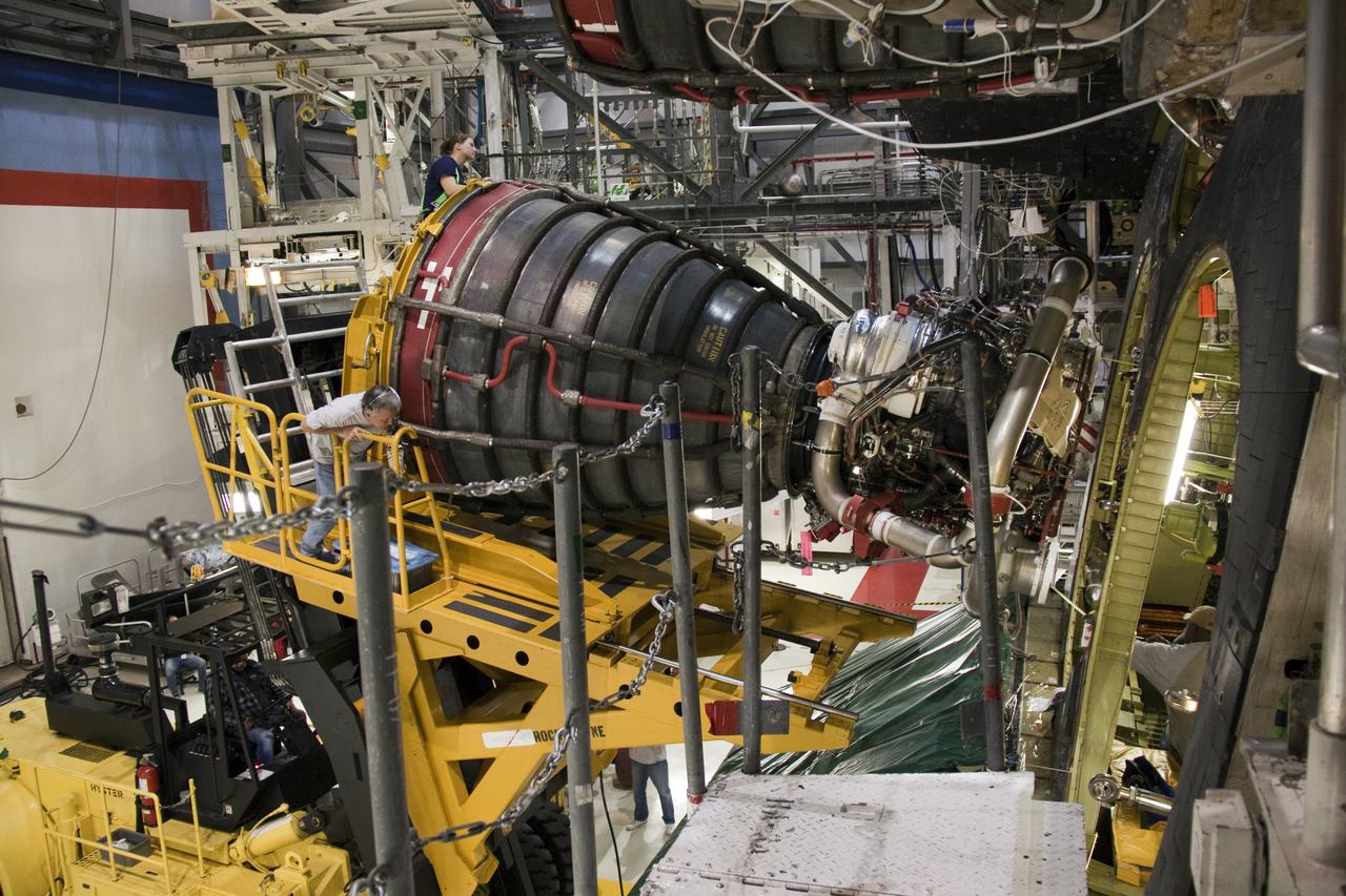 CAPE CANAVERAL, Fla. - In Orbiter Processing Facility-1 at NASA's Kennedy Space Center in Florida, workers use a Hyster forklift to slowly and carefully move a space shuttle main engine through an aperature on space shuttle Atlantis' aft end where it will be installed for the upcoming STS-132 mission. A main engine is 14 feet long, weighs approximately 7,000 pounds, and is 7.5 feet in diameter at the end of the nozzle. Inspection and maintenance of each of the shuttle's three main engines are an important safety measure and standard procedure between shuttle missions. Atlantis is scheduled to deliver an Integrated Cargo Carrier and Russian-built Mini Research Module to the International Space Station on STS-132. The second in a series of new pressurized components for Russia, the module will be permanently attached to the Zarya module. Three spacewalks are planned to store spare components outside the station, including six spare batteries, a boom assembly for the Ku-band antenna and spares for the Canadian Dextre robotic arm extension. A radiator, airlock and European robotic arm for the Russian Multi-purpose Laboratory Module also are payloads on the flight. Launch is targeted for May 14. Photo credit: NASA_Troy Cryder