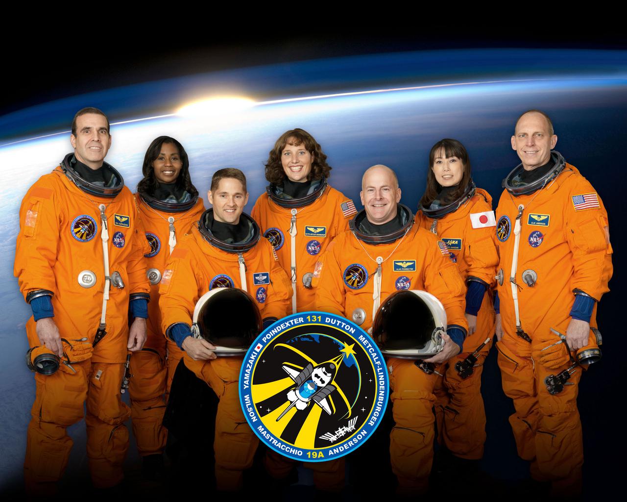 JOHNSON SPACE CENTER, Houston - STS131-S-002 - Attired in training versions of their shuttle launch and entry suits, these seven astronauts take a break from training to pose for the STS-131 crew portrait. Seated are NASA astronauts Alan Poindexter (right), commander; and James P. Dutton Jr., pilot. Pictured from the left (standing) are NASA astronauts Rick Mastracchio, Stephanie Wilson, Dorothy Metcalf-Lindenburger, Japan Aerospace Exploration Agency (JAXA) astronaut Naoko Yamazaki and NASA astronaut Clayton Anderson, all mission specialists.