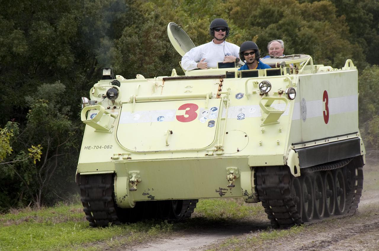 CAPE CANAVERAL, Fla. - At NASA's Kennedy Space Center in Florida, STS-131 Pilot James P. Dutton Jr. takes his instructor, Battalion Chief David Seymour, at left, for a ride in an M-113 armored personnel carrier during driving practice. Also along for the ride is astronaut Jerry Ross, chief of the Vehicle Integration Test Office at the Johnson Space Center. An M-113 is kept at the foot of the launch pad in case an emergency egress from the vicinity of the pad is needed. The crew members of space shuttle Discovery's STS-131 mission are at Kennedy for training related to their launch dress rehearsal, the Terminal Countdown Demonstration Test. The seven-member crew will deliver the multi-purpose logistics module Leonardo, filled with resupply stowage platforms and racks, to the International Space Station aboard Discovery. Targeted for launch on April 5, STS-131 will be the 33rd shuttle mission to the station and the 131st shuttle mission overall. For information on the STS-131 mission and crew, visit http:__www.nasa.gov_mission_pages_shuttle_shuttlemissions_sts131_index.html. Photo credit: NASA_Kim Shiflett