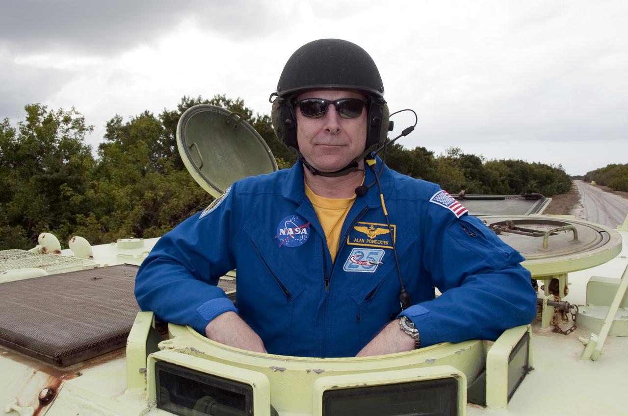 CAPE CANAVERAL, Fla. - At NASA's Kennedy Space Center in Florida, STS-131 Commander Alan Poindexter prepares to practice driving an M-113 armored personnel carrier.  An M-113 is kept at the foot of the launch pad in case an emergency egress from the vicinity of the pad is needed.  The crew members of space shuttle Discovery's STS-131 mission are at Kennedy for training related to their launch dress rehearsal, the Terminal Countdown Demonstration Test.  The seven-member crew will deliver the multi-purpose logistics module Leonardo, filled with resupply stowage platforms and racks, to the International Space Station aboard Discovery. Targeted for launch on April 5, STS-131 will be the 33rd shuttle mission to the station and the 131st shuttle mission overall. For information on the STS-131 mission and crew, visit http:__www.nasa.gov_mission_pages_shuttle_shuttlemissions_sts131_index.html. Photo credit: NASA_Kim Shiflett
