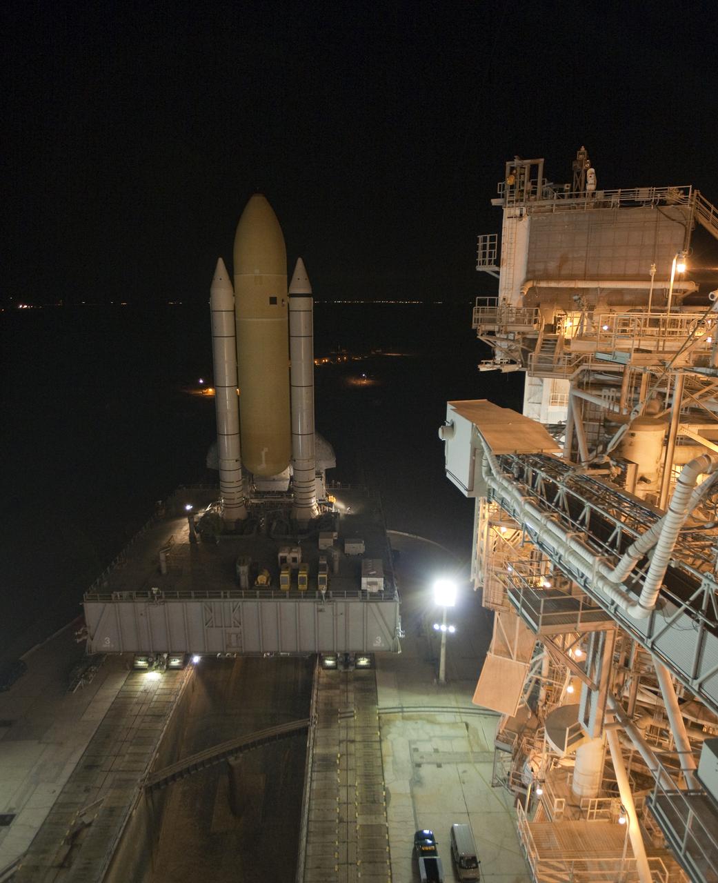 CAPE CANAVERAL, Fla. – Space shuttle Discovery rolls into place over the flame trench on Launch Pad 39A at NASA's Kennedy Space Center in Florida just before dawn. Discovery's first motion on its 3.4-mile trip from the Vehicle Assembly Building was at 11:58 p.m. EST March 2. The shuttle was secured on the pad at 6:48 a.m. March 3. Rollout is a significant milestone in launch processing activities. The seven-member STS-131 crew will deliver the multi-purpose logistics module Leonardo, filled with resupply stowage platforms and racks, to the International Space Station aboard Discovery. Targeted for launch on April 5, STS-131 will be the 33rd shuttle mission to the station and the 131st shuttle mission overall. For information on the STS-131 mission and crew, visit http:__www.nasa.gov_mission_pages_shuttle_shuttlemissions_sts131_index.html. Photo credit: NASA_Amanda Diller