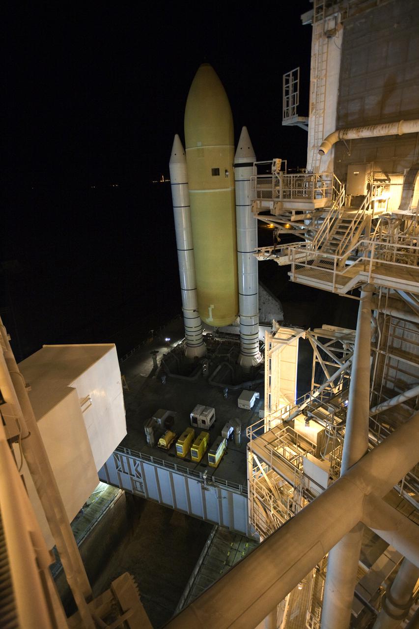 CAPE CANAVERAL, Fla. – Space shuttle Discovery rolls into place over the flame trench on Launch Pad 39A at NASA's Kennedy Space Center in Florida just before dawn. Discovery's first motion on its 3.4-mile trip from the Vehicle Assembly Building was at 11:58 p.m. EST March 2. The shuttle was secured on the pad at 6:48 a.m. March 3. Rollout is a significant milestone in launch processing activities. The seven-member STS-131 crew will deliver the multi-purpose logistics module Leonardo, filled with resupply stowage platforms and racks, to the International Space Station aboard Discovery. Targeted for launch on April 5, STS-131 will be the 33rd shuttle mission to the station and the 131st shuttle mission overall. For information on the STS-131 mission and crew, visit http:__www.nasa.gov_mission_pages_shuttle_shuttlemissions_sts131_index.html. Photo credit: NASA_Amanda Diller