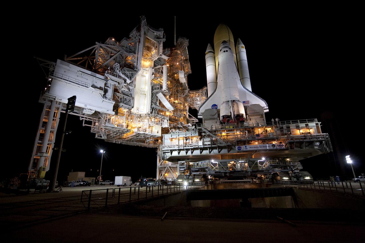 CAPE CANAVERAL, Fla. – The rotating service structure, at left, is retracted on Launch Pad 39A at NASA's Kennedy Space Center in Florida to receive space shuttle Discovery. Discovery's first motion on its 3.4-mile trip from the Vehicle Assembly Building was at 11:58 p.m. EST March 2. The shuttle was secured on the pad at 6:48 a.m. March 3. Rollout is a significant milestone in launch processing activities. The seven-member STS-131 crew will deliver the multi-purpose logistics module Leonardo, filled with resupply stowage platforms and racks, to the International Space Station aboard Discovery. Targeted for launch on April 5, STS-131 will be the 33rd shuttle mission to the station and the 131st shuttle mission overall. For information on the STS-131 mission and crew, visit http:__www.nasa.gov_mission_pages_shuttle_shuttlemissions_sts131_index.html. Photo credit: NASA_Amanda Diller