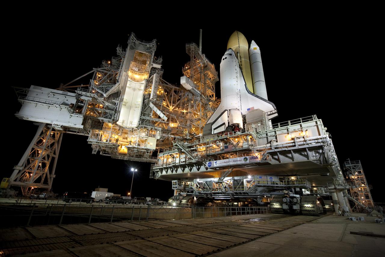 CAPE CANAVERAL, Fla. – The rotating and fixed service structures are brightly lit on Launch Pad 39A at NASA's Kennedy Space Center in Florida for the arrival of space shuttle Discovery just before sunrise. Discovery's first motion on its 3.4-mile trip from the Vehicle Assembly Building was at 11:58 p.m. EST March 2. The shuttle was secured on the pad at 6:48 a.m. March 3. Rollout is a significant milestone in launch processing activities. The seven-member STS-131 crew will deliver the multi-purpose logistics module Leonardo, filled with resupply stowage platforms and racks, to the International Space Station aboard Discovery. Targeted for launch on April 5, STS-131 will be the 33rd shuttle mission to the station and the 131st shuttle mission overall. For information on the STS-131 mission and crew, visit http:__www.nasa.gov_mission_pages_shuttle_shuttlemissions_sts131_index.html. Photo credit: NASA_Amanda Diller