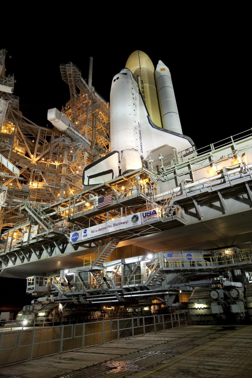 CAPE CANAVERAL, Fla. – On Launch Pad 39A at NASA's Kennedy Space Center in Florida, the crawler-transporter beneath space shuttle Discovery crosses over the pad's flame trench. Discovery's first motion on its 3.4-mile trip from the Vehicle Assembly Building was at 11:58 p.m. EST March 2. The shuttle was secured on the pad at 6:48 a.m. March 3. Rollout is a significant milestone in launch processing activities. The seven-member STS-131 crew will deliver the multi-purpose logistics module Leonardo, filled with resupply stowage platforms and racks, to the International Space Station aboard Discovery. Targeted for launch on April 5, STS-131 will be the 33rd shuttle mission to the station and the 131st shuttle mission overall. For information on the STS-131 mission and crew, visit http:__www.nasa.gov_mission_pages_shuttle_shuttlemissions_sts131_index.html. Photo credit: NASA_Amanda Diller