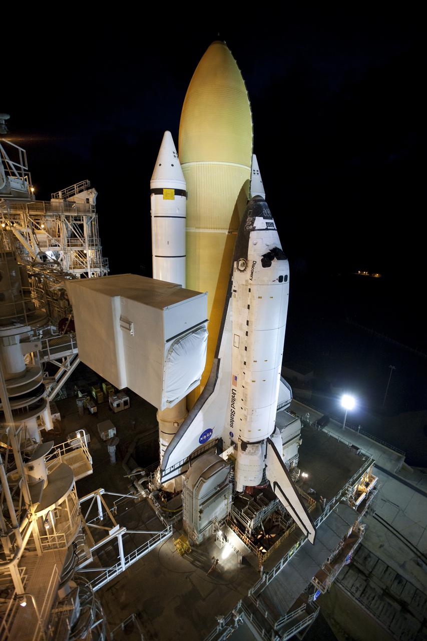 CAPE CANAVERAL, Fla. – On Launch Pad 39A at NASA's Kennedy Space Center in Florida, the pad's White Room, which provides workers and astronauts an entry point to a shuttle's crew compartment, awaits placement against space shuttle Discovery. Discovery's first motion on its 3.4-mile trip from the Vehicle Assembly Building was at 11:58 p.m. EST March 2. The shuttle was secured on the pad at 6:48 a.m. March 3. Rollout is a significant milestone in launch processing activities. The seven-member STS-131 crew will deliver the multi-purpose logistics module Leonardo, filled with resupply stowage platforms and racks, to the International Space Station aboard Discovery. Targeted for launch on April 5, STS-131 will be the 33rd shuttle mission to the station and the 131st shuttle mission overall. For information on the STS-131 mission and crew, visit http:__www.nasa.gov_mission_pages_shuttle_shuttlemissions_sts131_index.html. Photo credit: NASA_Amanda Diller