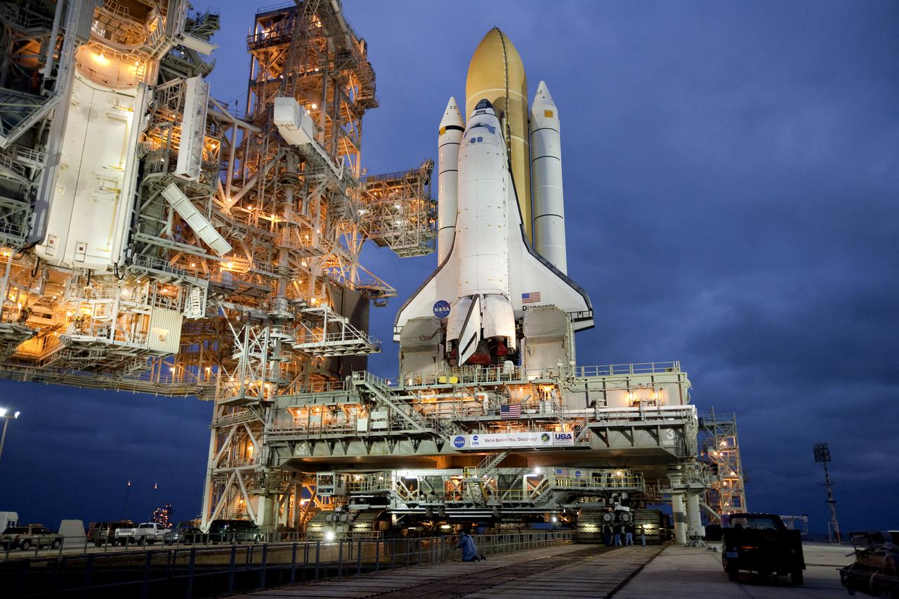 CAPE CANAVERAL, Fla. – Dawn at Launch Pad 39A at NASA's Kennedy Space Center in Florida finds NASA and United Space Alliance employees hard at work securing space shuttle Discovery to the pad. Discovery's first motion on its 3.4-mile trip from the Vehicle Assembly Building was at 11:58 p.m. EST March 2. The shuttle was secured on the pad at 6:48 a.m. March 3. Rollout is a significant milestone in launch processing activities. The seven-member STS-131 crew will deliver the multi-purpose logistics module Leonardo, filled with resupply stowage platforms and racks, to the International Space Station aboard Discovery. Targeted for launch on April 5, STS-131 will be the 33rd shuttle mission to the station and the 131st shuttle mission overall. For information on the STS-131 mission and crew, visit http:__www.nasa.gov_mission_pages_shuttle_shuttlemissions_sts131_index.html. Photo credit: NASA_Amanda Diller