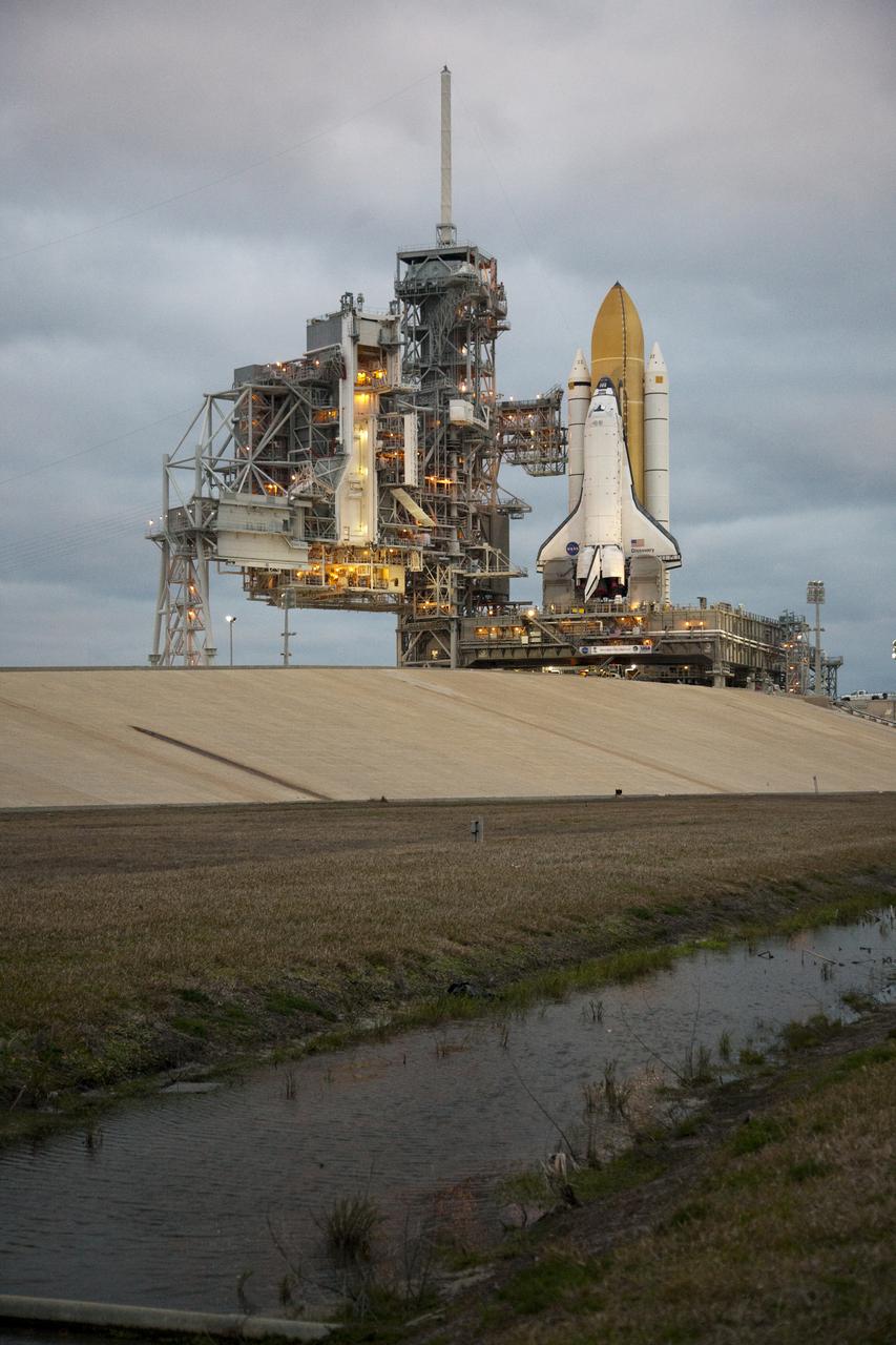 CAPE CANAVERAL, Fla. – The sun rises over Launch Pad 39A at NASA's Kennedy Space Center in Florida to a cloud-filled sky and operations under way to secure space shuttle Discovery to the pad. Discovery's first motion on its 3.4-mile trip from the Vehicle Assembly Building was at 11:58 p.m. EST March 2. The shuttle was secured on the pad at 6:48 a.m. March 3. Rollout is a significant milestone in launch processing activities. The seven-member STS-131 crew will deliver the multi-purpose logistics module Leonardo, filled with resupply stowage platforms and racks, to the International Space Station aboard Discovery. Targeted for launch on April 5, STS-131 will be the 33rd shuttle mission to the station and the 131st shuttle mission overall. For information on the STS-131 mission and crew, visit http:__www.nasa.gov_mission_pages_shuttle_shuttlemissions_sts131_index.html. Photo credit: NASA_Amanda Diller