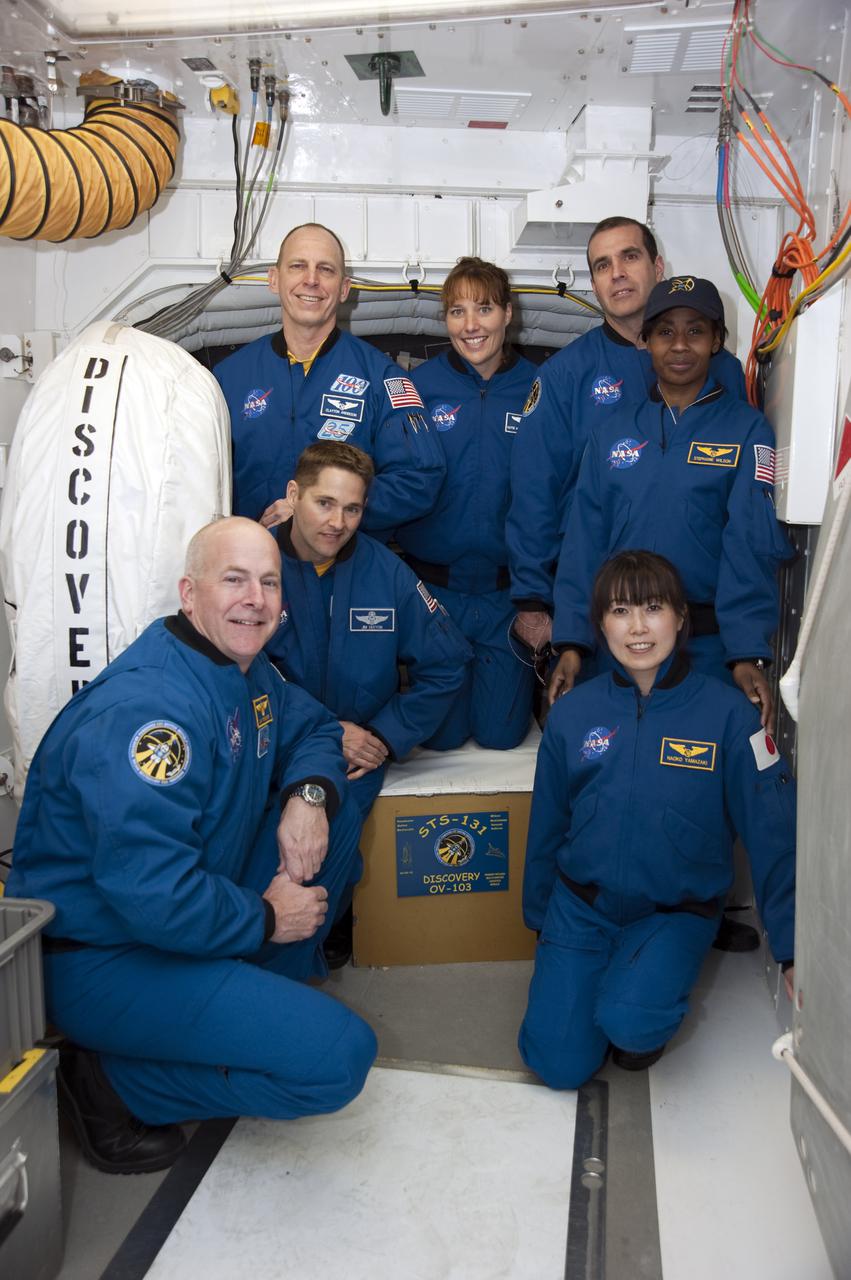 CAPE CANAVERAL, Fla. - At Launch Pad 39A at NASA's Kennedy Space Center in Florida, the members of space shuttle Discovery's STS-131 crew take time out from their training to pose for a group portrait in the pad's White Room.  Kneeling, from left, are Commander Alan Poindexter, Pilot James P. Dutton Jr., and Mission Specialist Naoko Yamazaki of the Japan Aerospace Exploration Agency.  Standing, from left, are Mission Specialists Clayton Anderson, Dorothy Metcalf-Lindenburger, Rick Mastracchio and Stephanie Wilson.  Behind them is the hatch through which they will enter Discovery's crew compartment for their countdown rehearsal.  The crew members of space shuttle Discovery's STS-131 mission are at Kennedy for training related to their launch dress rehearsal, the Terminal Countdown Demonstration Test.  The seven-member crew will deliver the multi-purpose logistics module Leonardo, filled with resupply stowage platforms and racks, to the International Space Station aboard Discovery. Targeted for launch on April 5, STS-131 will be the 33rd shuttle mission to the station and the 131st shuttle mission overall. For information on the STS-131 mission and crew, visit http:__www.nasa.gov_mission_pages_shuttle_shuttlemissions_sts131_index.html. Photo credit: NASA_Kim Shiflett