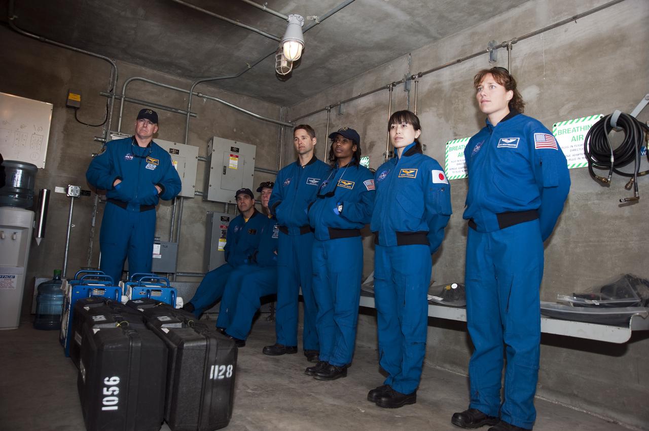 CAPE CANAVERAL, Fla. - On Launch Pad 39A at NASA's Kennedy Space Center in Florida, the members of space shuttle Discovery's STS-131 crew continue their emergency exit training in a bunker near the catch nets for the slidewire baskets at the base of the pad.  The bunker would provide a safe haven for the astronauts if evacuation of the pad were required.  From left are Commander Alan Poindexter; Mission Specialists Rick Mastracchio and Clayton Anderson; Pilot James P. Dutton Jr.; and Mission Specialists Stephanie Wilson, Naoko Yamazaki of the Japan Aerospace Exploration Agency, and Dorothy Metcalf-Lindenburger.  The crew members of space shuttle Discovery's STS-131 mission are at Kennedy for training related to their launch dress rehearsal, the Terminal Countdown Demonstration Test.  The seven-member crew will deliver the multi-purpose logistics module Leonardo, filled with resupply stowage platforms and racks, to the International Space Station aboard Discovery. Targeted for launch on April 5, STS-131 will be the 33rd shuttle mission to the station and the 131st shuttle mission overall. For information on the STS-131 mission and crew, visit http:__www.nasa.gov_mission_pages_shuttle_shuttlemissions_sts131_index.html. Photo credit: NASA_Kim Shiflett