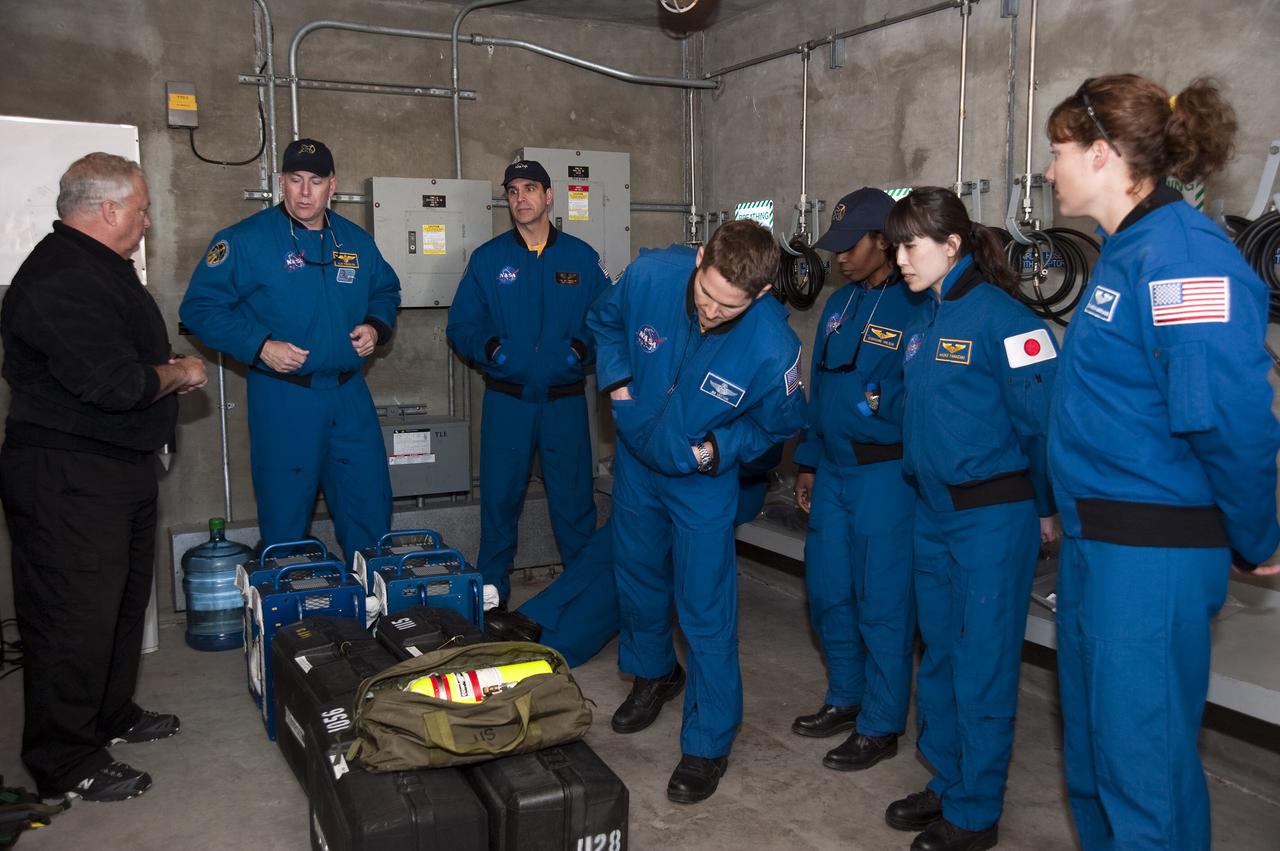CAPE CANAVERAL, Fla. - On Launch Pad 39A at NASA's Kennedy Space Center in Florida, the members of space shuttle Discovery's STS-131 crew continue their emergency exit training in a bunker near the catch nets for the slidewire baskets at the base of the pad.  The bunker would provide a safe haven for the astronauts if evacuation of the pad were required.  From left, in the blue flight suits, are Commander Alan Poindexter; Mission Specialist Rick Mastracchio; Pilot James P. Dutton Jr.; and Mission Specialists Stephanie Wilson, Naoko Yamazaki of the Japan Aerospace Exploration Agency, and Dorothy Metcalf-Lindenburger.  The crew members of space shuttle Discovery's STS-131 mission are at Kennedy for training related to their launch dress rehearsal, the Terminal Countdown Demonstration Test.  The seven-member crew will deliver the multi-purpose logistics module Leonardo, filled with resupply stowage platforms and racks, to the International Space Station aboard Discovery. Targeted for launch on April 5, STS-131 will be the 33rd shuttle mission to the station and the 131st shuttle mission overall. For information on the STS-131 mission and crew, visit http:__www.nasa.gov_mission_pages_shuttle_shuttlemissions_sts131_index.html. Photo credit: NASA_Kim Shiflett