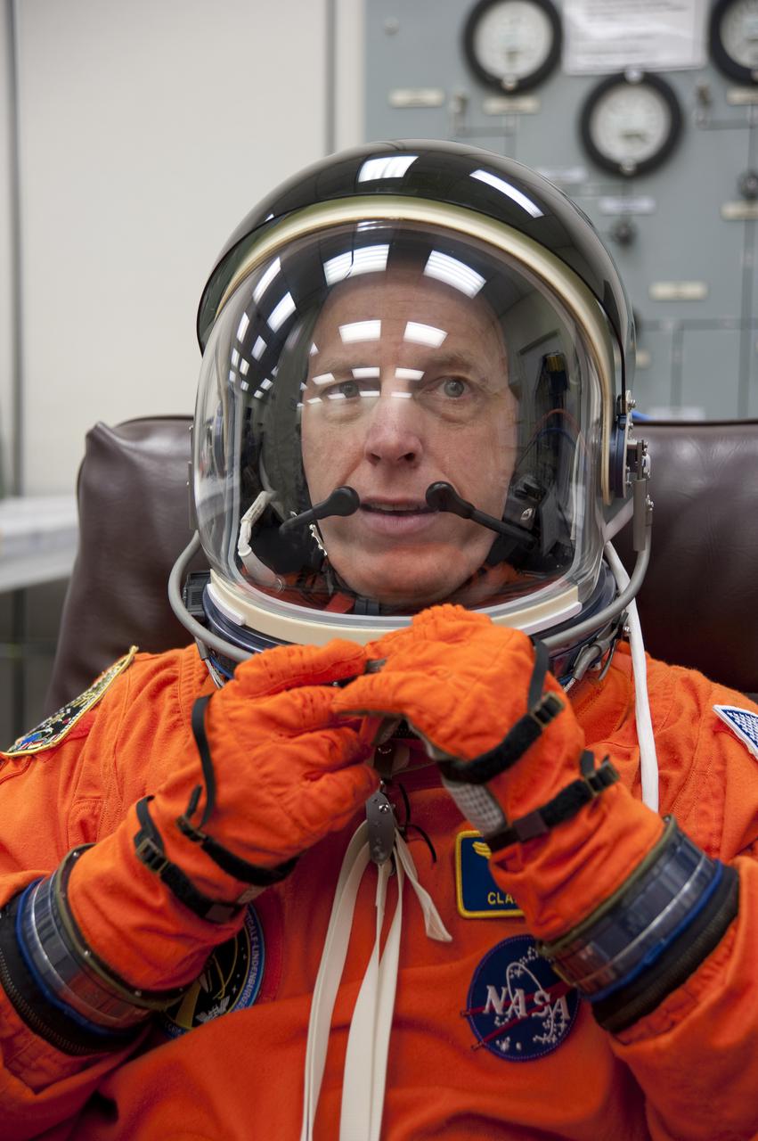 CAPE CANAVERAL, Fla. - In the Operations and Checkout Building at NASA's Kennedy Space Center in Florida, STS-131 Mission Specialist Clayton Anderson verifies that his helmet is functioning properly. The members of space shuttle Discovery's STS-131 crew put on their launch-and-entry suits before heading to the Astrovan for the ride to Launch Pad 39A. The crew is participating in the Terminal Countdown Demonstration Test, or TCDT, a dress rehearsal for launch. TCDT includes training on the emergency egress systems at the launch pad, driving practice of the M-113 armored personnel carrier and a simulated launch countdown. The crew will deliver the multi-purpose logistics module Leonard, filled with resupply stowage platforms and science racks, to the International Space Station. STS-131, targeted for launch on April 5, will be the 33rd shuttle mission to the station and the 131st shuttle mission overall. For information on the STS-131 mission and crew, visit http:__www.nasa.gov_mission_pages_shuttle_shuttlemissions_sts131_index.htm. Photo credit: NASA_Kim Shiflett