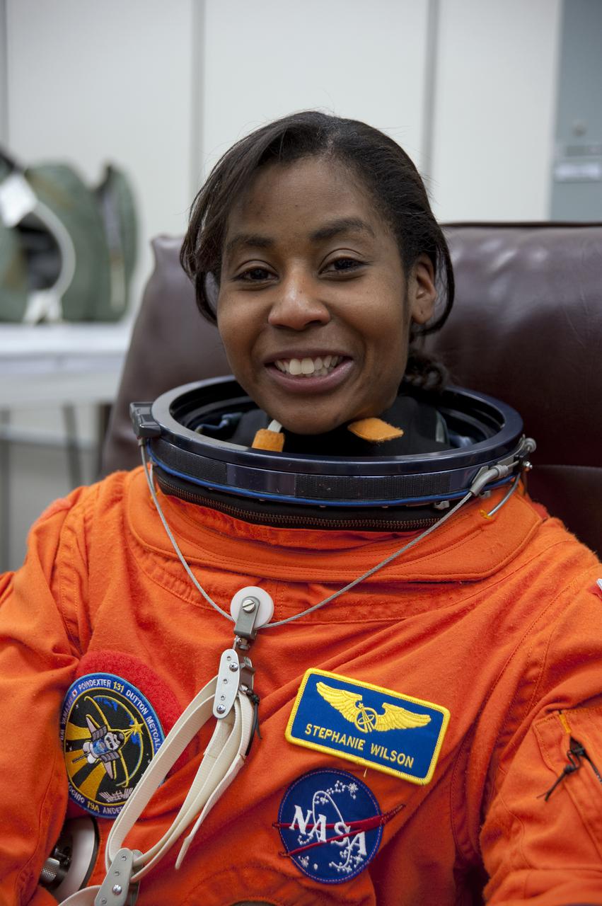 CAPE CANAVERAL, Fla. - In the Operations and Checkout Building at NASA's Kennedy Space Center in Florida, STS-131 Mission Specialist Stephanie Wilson seems pleased with the fit of her spacesuit. The members of space shuttle Discovery's STS-131 crew put on their launch-and-entry suits before heading to the Astrovan for the ride to Launch Pad 39A. The crew is participating in the Terminal Countdown Demonstration Test, or TCDT, a dress rehearsal for launch. TCDT includes training on the emergency egress systems at the launch pad, driving practice of the M-113 armored personnel carrier and a simulated launch countdown. The crew will deliver the multi-purpose logistics module Leonard, filled with resupply stowage platforms and science racks, to the International Space Station. STS-131, targeted for launch on April 5, will be the 33rd shuttle mission to the station and the 131st shuttle mission overall. For information on the STS-131 mission and crew, visit http:__www.nasa.gov_mission_pages_shuttle_shuttlemissions_sts131_index.htm. Photo credit: NASA_Kim Shiflett