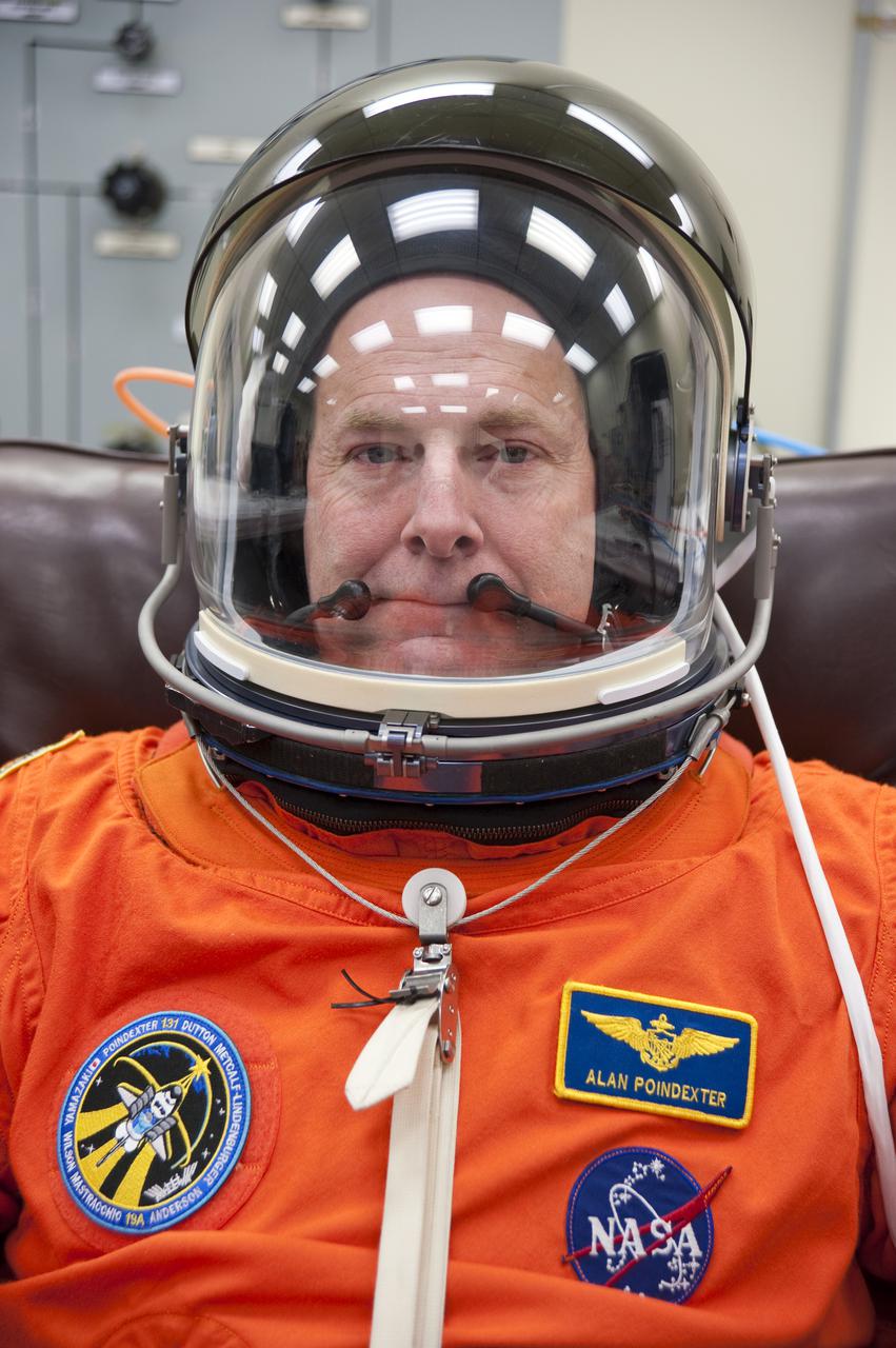 CAPE CANAVERAL, Fla. - In the Operations and Checkout Building at NASA's Kennedy Space Center in Florida, STS-131 Commander Alan Poindexter verifies that his helmet is functioning properly. The members of space shuttle Discovery's STS-131 crew put on their launch-and-entry suits before heading to the Astrovan for the ride to Launch Pad 39A. The crew is participating in the Terminal Countdown Demonstration Test, or TCDT, a dress rehearsal for launch. TCDT includes training on the emergency egress systems at the launch pad, driving practice of the M-113 armored personnel carrier and a simulated launch countdown. The crew will deliver the multi-purpose logistics module Leonard, filled with resupply stowage platforms and science racks, to the International Space Station. STS-131, targeted for launch on April 5, will be the 33rd shuttle mission to the station and the 131st shuttle mission overall. For information on the STS-131 mission and crew, visit http:__www.nasa.gov_mission_pages_shuttle_shuttlemissions_sts131_index.htm. Photo credit: NASA_Kim Shiflett