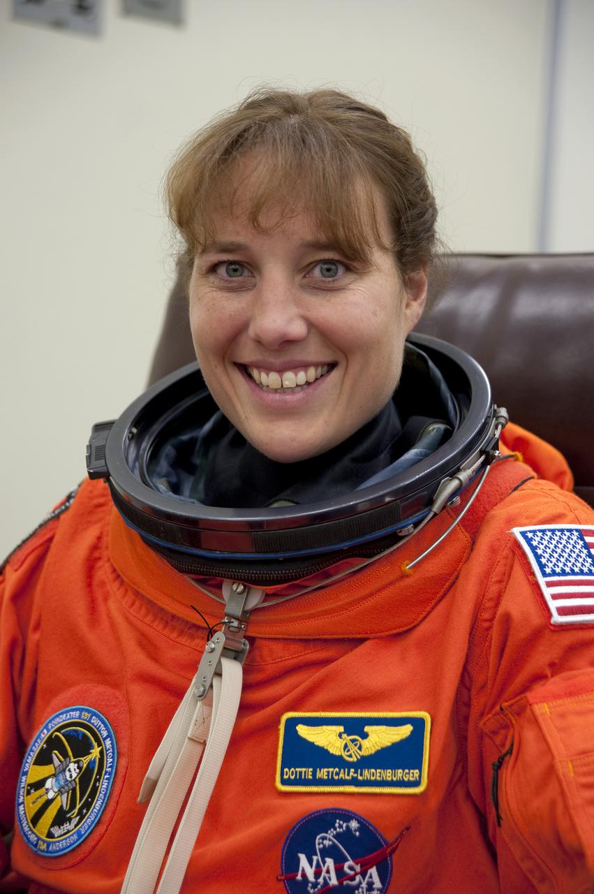 CAPE CANAVERAL, Fla. - In the Operations and Checkout Building at NASA's Kennedy Space Center in Florida, STS-131 Mission Specialist Dorothy Metcalf-Lindenburger seems pleased with the fit of her spacesuit. The members of space shuttle Discovery's STS-131 crew put on their launch-and-entry suits before heading to the Astrovan for the ride to Launch Pad 39A. The crew is participating in the Terminal Countdown Demonstration Test, or TCDT, a dress rehearsal for launch. TCDT includes training on the emergency egress systems at the launch pad, driving practice of the M-113 armored personnel carrier and a simulated launch countdown. The crew will deliver the multi-purpose logistics module Leonard, filled with resupply stowage platforms and science racks, to the International Space Station. STS-131, targeted for launch on April 5, will be the 33rd shuttle mission to the station and the 131st shuttle mission overall. For information on the STS-131 mission and crew, visit http:__www.nasa.gov_mission_pages_shuttle_shuttlemissions_sts131_index.htm. Photo credit: NASA_Kim Shiflett