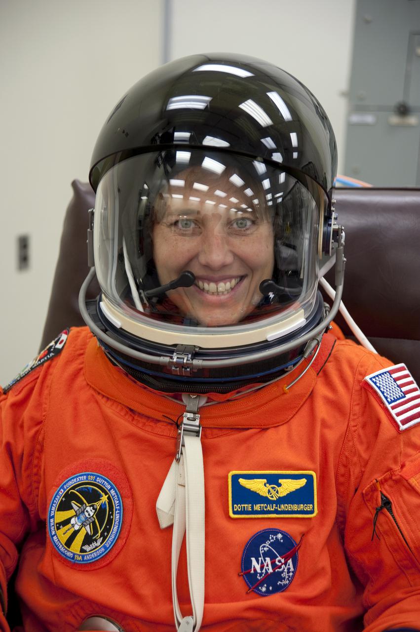 CAPE CANAVERAL, Fla. - In the Operations and Checkout Building at NASA's Kennedy Space Center in Florida, STS-131 Mission Specialist Dorothy Metcalf-Lindenburger verifies that her helmet is functioning properly.   The members of space shuttle Discovery's STS-131 crew put on their launch-and-entry suits before heading to the Astrovan for the ride to Launch Pad 39A.  The crew is participating in the Terminal Countdown Demonstration Test, or TCDT, a dress rehearsal for launch.  TCDT includes training on the emergency egress systems at the launch pad, driving practice of the M-113 armored personnel carrier and a simulated launch countdown. The crew will deliver the multi-purpose logistics module Leonard, filled with resupply stowage platforms and science racks, to the International Space Station. STS-131, targeted for launch on April 5, will be the 33rd shuttle mission to the station and the 131st shuttle mission overall. For information on the STS-131 mission and crew, visit http:__www.nasa.gov_mission_pages_shuttle_shuttlemissions_sts131_index.htm. Photo credit: NASA_Kim Shiflett