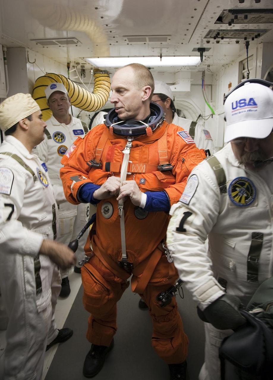 CAPE CANAVERAL, Fla. - At Launch Pad 39A at NASA's Kennedy Space Center in Florida, STS-131 Mission Specialist Clayton Anderson prepares to enter space shuttle Discovery from the pad's White Room.  The crew members of Discovery's STS-131 mission, dressed in their launch-and-entry suits, are participating in the Terminal Countdown Demonstration Test, or TCDT, a dress rehearsal for launch.  TCDT includes training on the emergency exit systems at the launch pad, driving practice of the M-113 armored personnel carrier and a simulated launch countdown. The crew will deliver the multi-purpose logistics module Leonard, filled with resupply stowage platforms and science racks, to the International Space Station. STS-131, targeted for launch on April 5, will be the 33rd shuttle mission to the station and the 131st shuttle mission overall. For information on the STS-131 mission and crew, visit http:__www.nasa.gov_mission_pages_shuttle_shuttlemissions_sts131_index.htm. Photo credit: NASA_Dimitri Gerondidakis