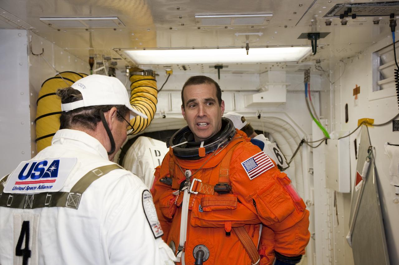 CAPE CANAVERAL, Fla. - At Launch Pad 39A at NASA's Kennedy Space Center in Florida, STS-131 Mission Specialist Rick Mastracchio prepares to enter space shuttle Discovery from the pad's White Room.  The crew members of Discovery's STS-131 mission, dressed in their launch-and-entry suits, are participating in the Terminal Countdown Demonstration Test, or TCDT, a dress rehearsal for launch.  TCDT includes training on the emergency exit systems at the launch pad, driving practice of the M-113 armored personnel carrier and a simulated launch countdown. The crew will deliver the multi-purpose logistics module Leonard, filled with resupply stowage platforms and science racks, to the International Space Station. STS-131, targeted for launch on April 5, will be the 33rd shuttle mission to the station and the 131st shuttle mission overall. For information on the STS-131 mission and crew, visit http:__www.nasa.gov_mission_pages_shuttle_shuttlemissions_sts131_index.htm. Photo credit: NASA_Dimitri Gerondidakis