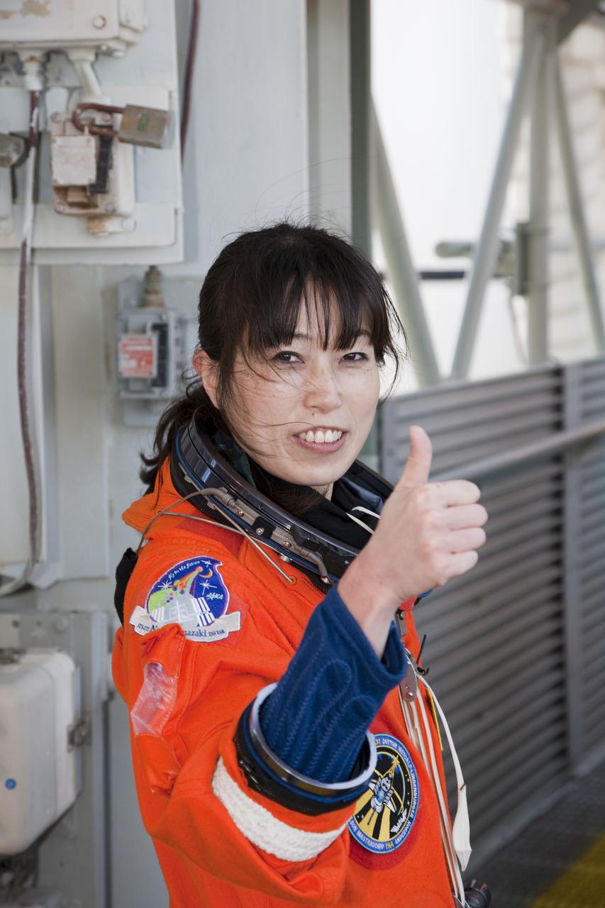 CAPE CANAVERAL, Fla. - At Launch Pad 39A at NASA's Kennedy Space Center in Florida, STS-131 Mission Specialist Naoko Yamazaki of the Japan Aerospace Exploration Agency awaits her turn to enter space shuttle Discovery. The crew members of Discovery's STS-131 mission, dressed in their launch-and-entry suits, are participating in the Terminal Countdown Demonstration Test, or TCDT, a dress rehearsal for launch. TCDT includes training on the emergency exit systems at the launch pad, driving practice of the M-113 armored personnel carrier and a simulated launch countdown. The crew will deliver the multi-purpose logistics module Leonard, filled with resupply stowage platforms and science racks, to the International Space Station. STS-131, targeted for launch on April 5, will be the 33rd shuttle mission to the station and the 131st shuttle mission overall. For information on the STS-131 mission and crew, visit http:__www.nasa.gov_mission_pages_shuttle_shuttlemissions_sts131_index.htm. Photo credit: NASA_Dimitri Gerondidakis
