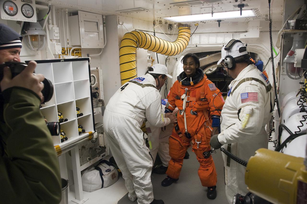 CAPE CANAVERAL, Fla. - At Launch Pad 39A at NASA's Kennedy Space Center in Florida, STS-131 Mission Specialist Stephanie Wilson prepares to enter space shuttle Discovery from the pad's White Room.  The members of space shuttle Discovery's STS-131 crew, dressed in their launch-and-entry suits, are participating in the Terminal Countdown Demonstration Test, or TCDT, a dress rehearsal for launch.  TCDT includes training on the emergency exit systems at the launch pad, driving practice of the M-113 armored personnel carrier and a simulated launch countdown. The crew will deliver the multi-purpose logistics module Leonard, filled with resupply stowage platforms and science racks, to the International Space Station. STS-131, targeted for launch on April 5, will be the 33rd shuttle mission to the station and the 131st shuttle mission overall. For information on the STS-131 mission and crew, visit http:__www.nasa.gov_mission_pages_shuttle_shuttlemissions_sts131_index.htm. Photo credit: NASA_Regina Mitchell-Ryall